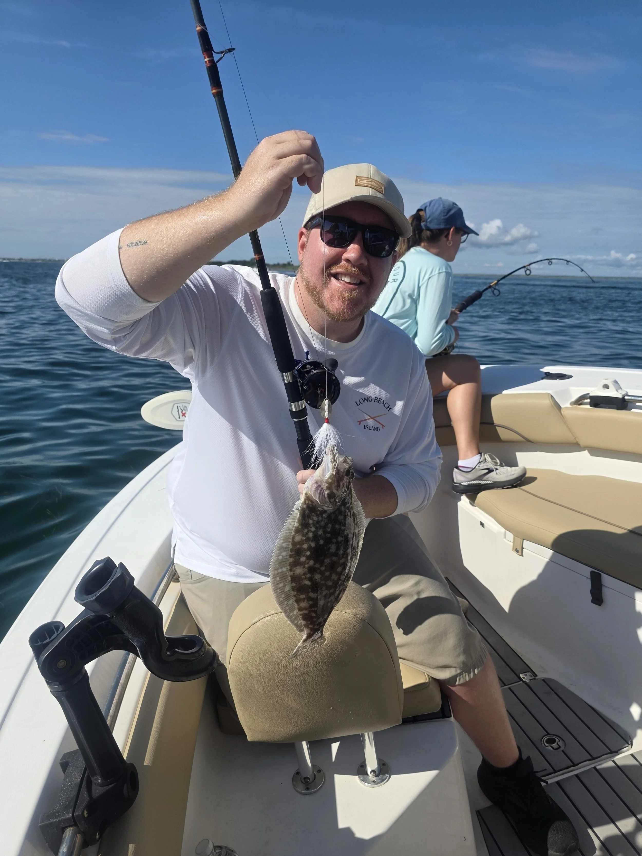 Dad showing off catch while mom is hooked up