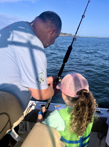 4-year-old girl catching her first fish