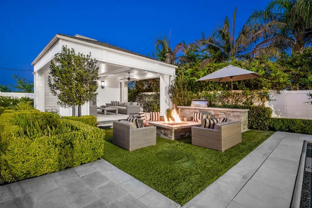 luxury backyard with fire pit built in bbq and large covered patio structure