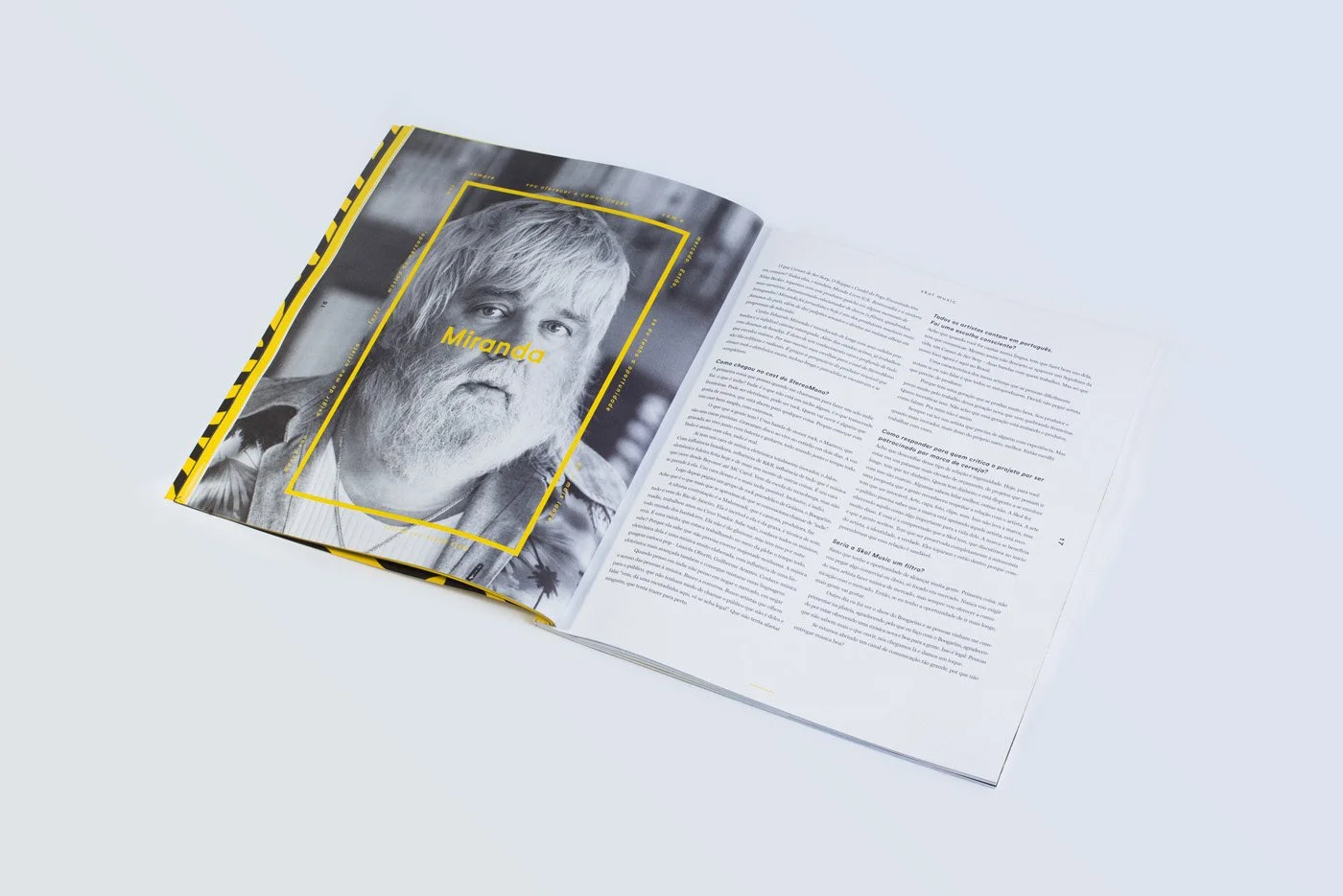 Open magazine showing a black and white portrait of an older man with a beard, labeled "Miranda," alongside a page of text in Portuguese.