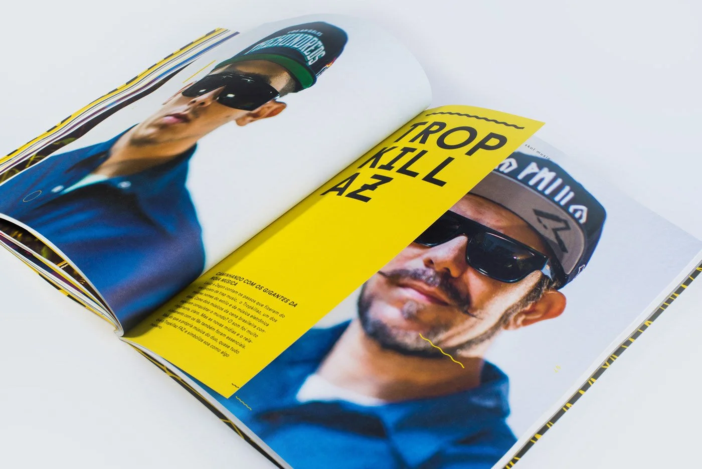Open magazine with two pages, featuring a man wearing sunglasses and a cap. The background of the page is yellow with large black text and some smaller text on the bottom left.
