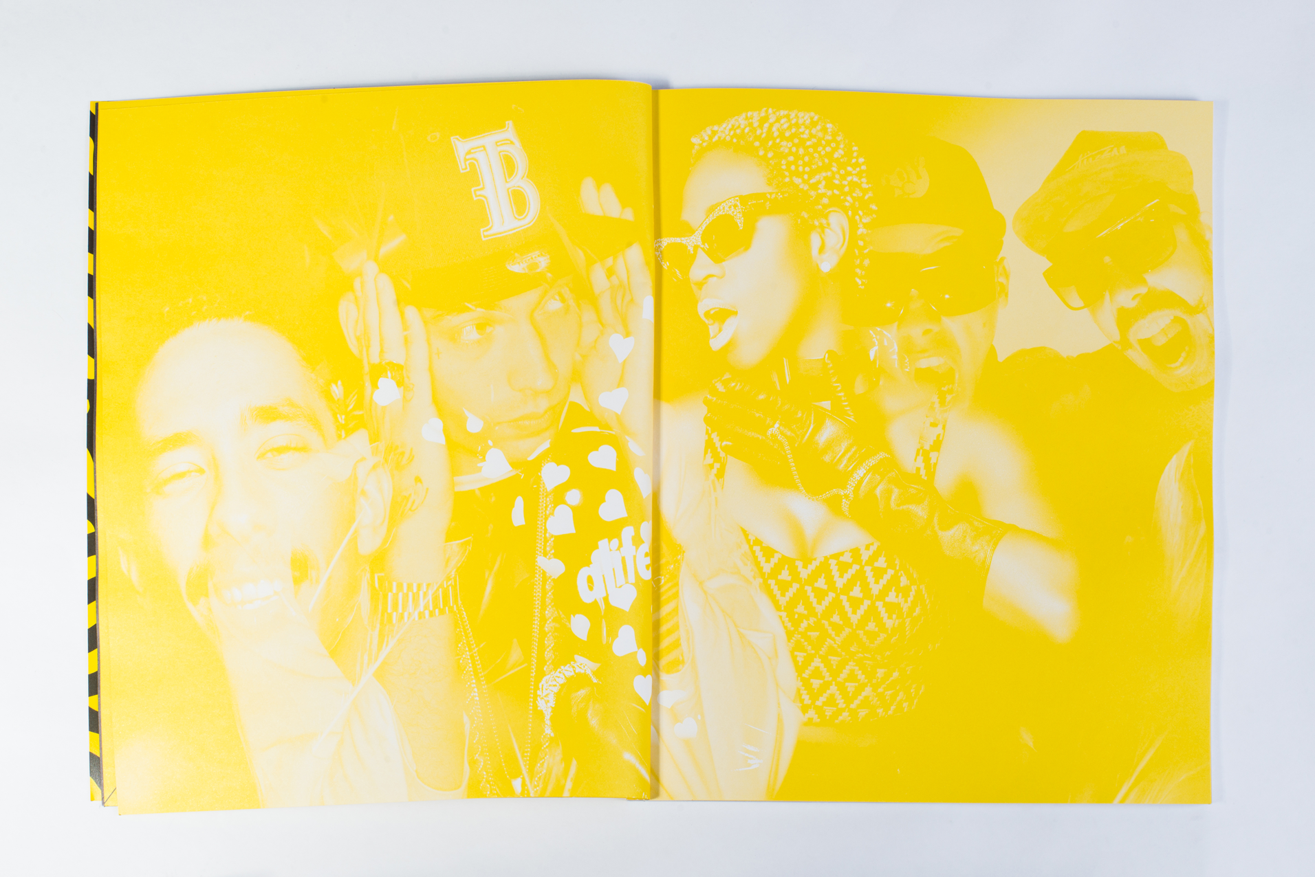 Artistic photo of people in yellow hue, open book layout.