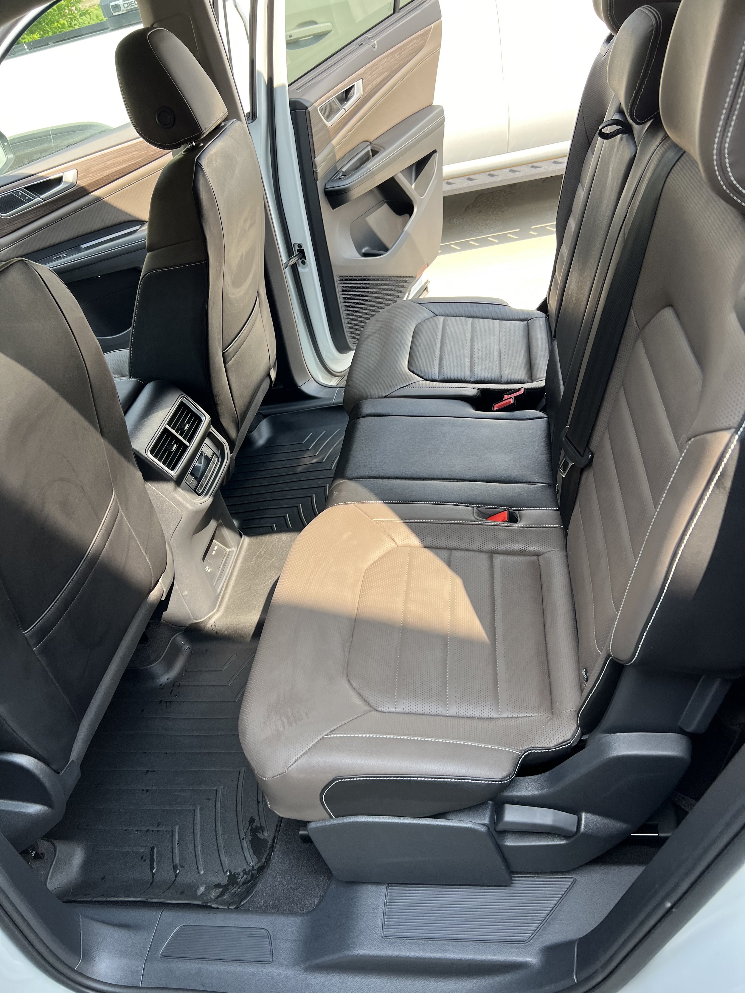 Interior of a car showing the back seat with leather upholstery.