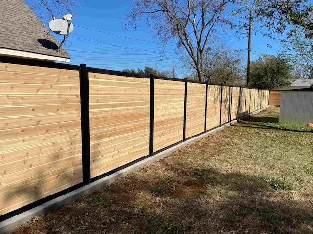 Wooden privacy fence with black metal posts