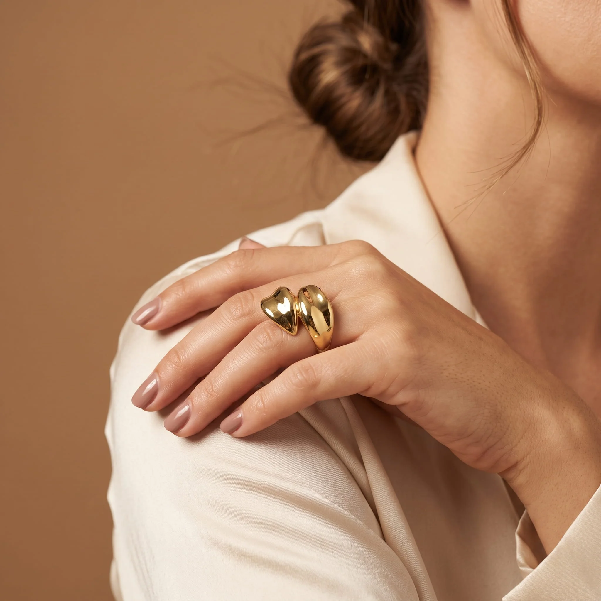 Firefly_Gemini Flash_A polished yellow-gold sculptural bypass ring built from two smooth domed lobes that  517605.jpg (Copy)