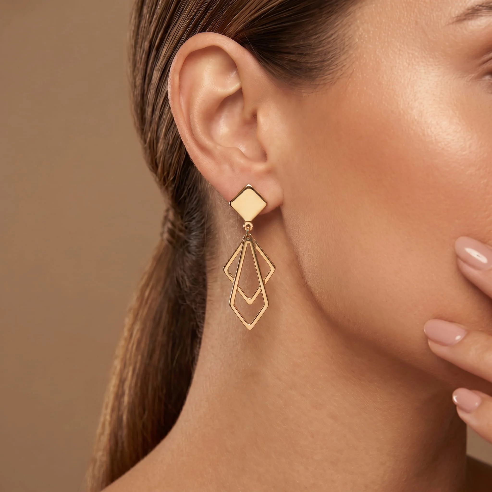 Firefly_Gemini Flash_A close-up profile of a woman's ear wearing a modern geometric yellow-gold drop earri 251278.jpg
