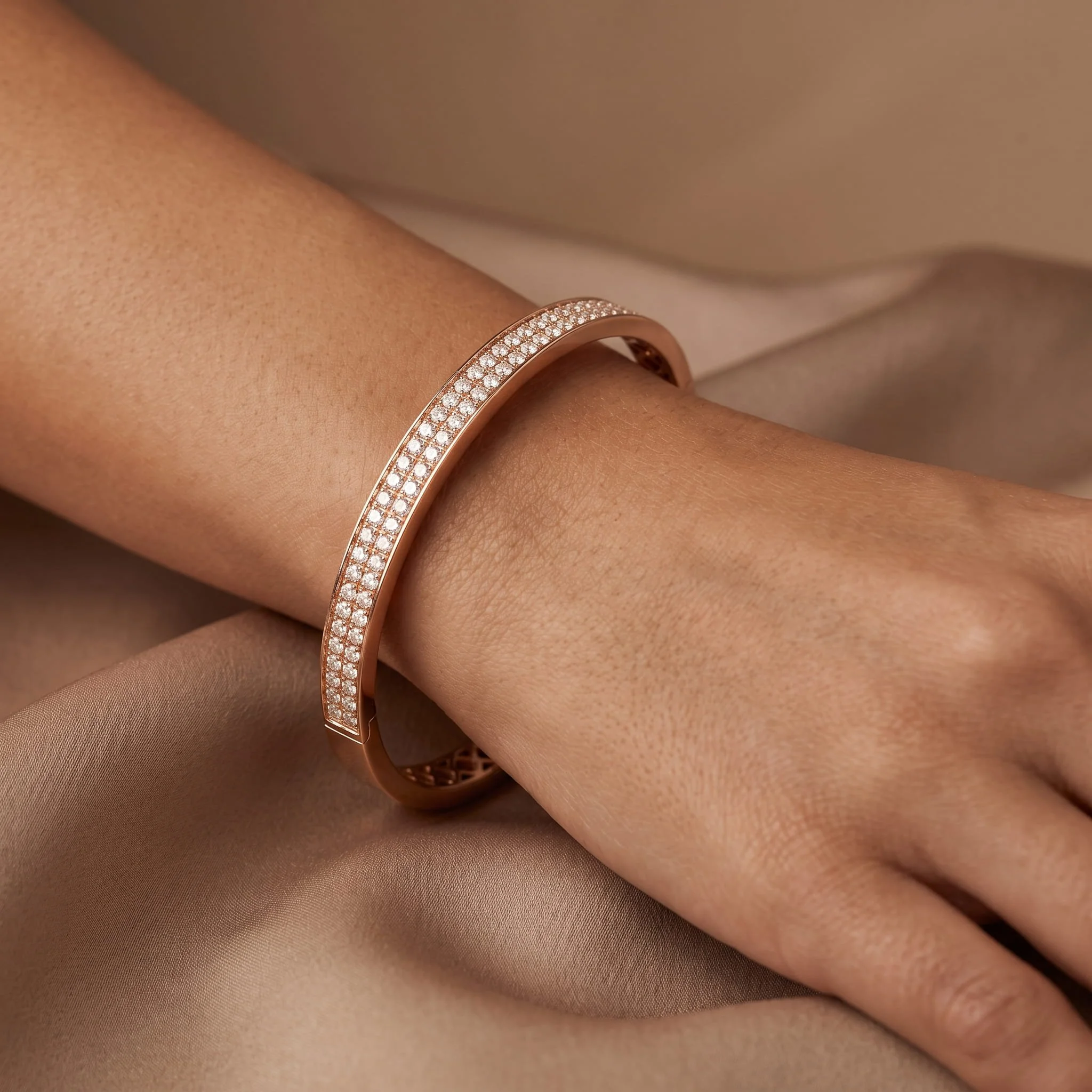 Firefly_Gemini Flash_A rose-gold pavé diamond hinged bangle worn on the wrist, the band set along its top  517292.jpg