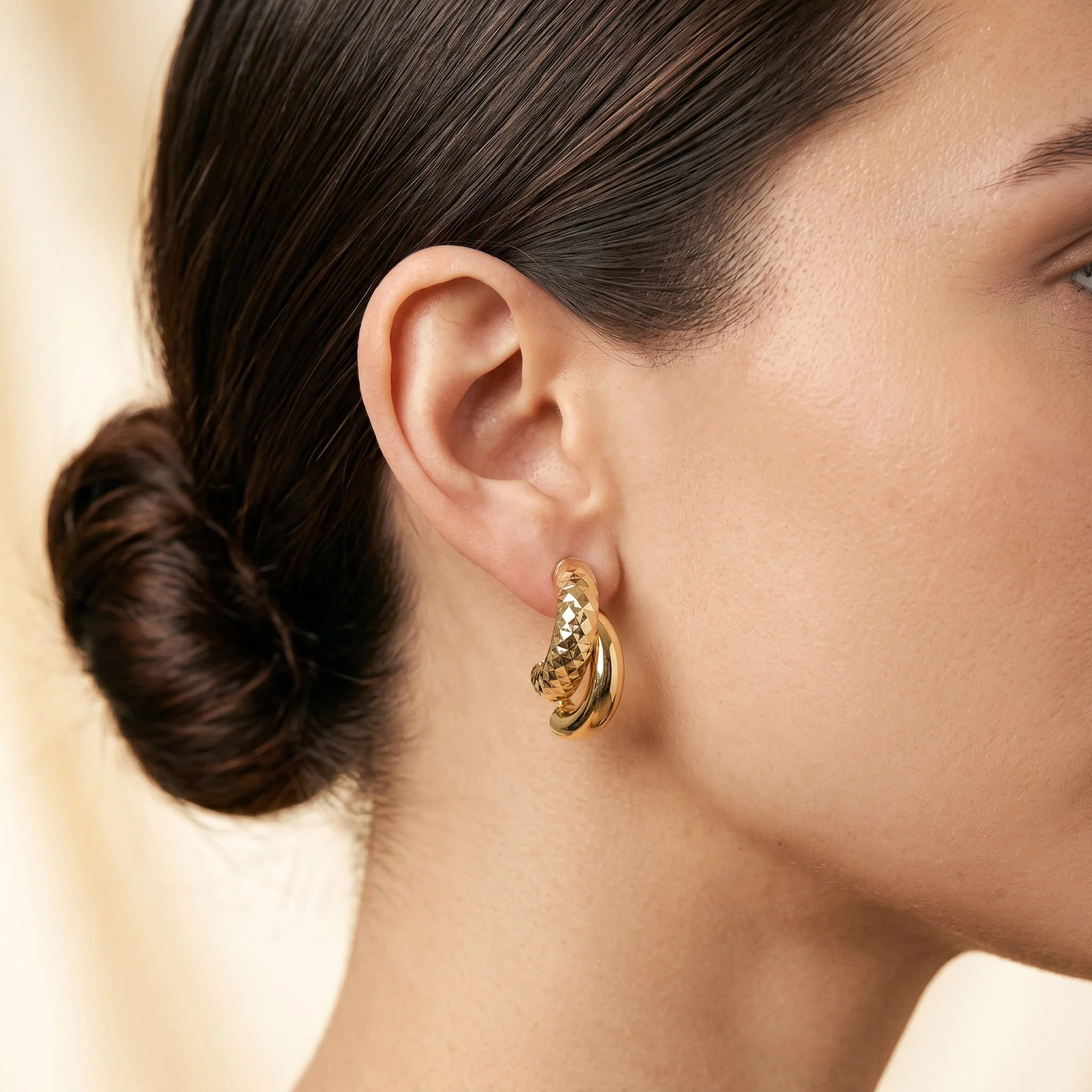 Firefly_Gemini Flash_Close-up profile of a woman's ear wearing an 18K yellow gold double-band half-hoop ea 666066.jpg