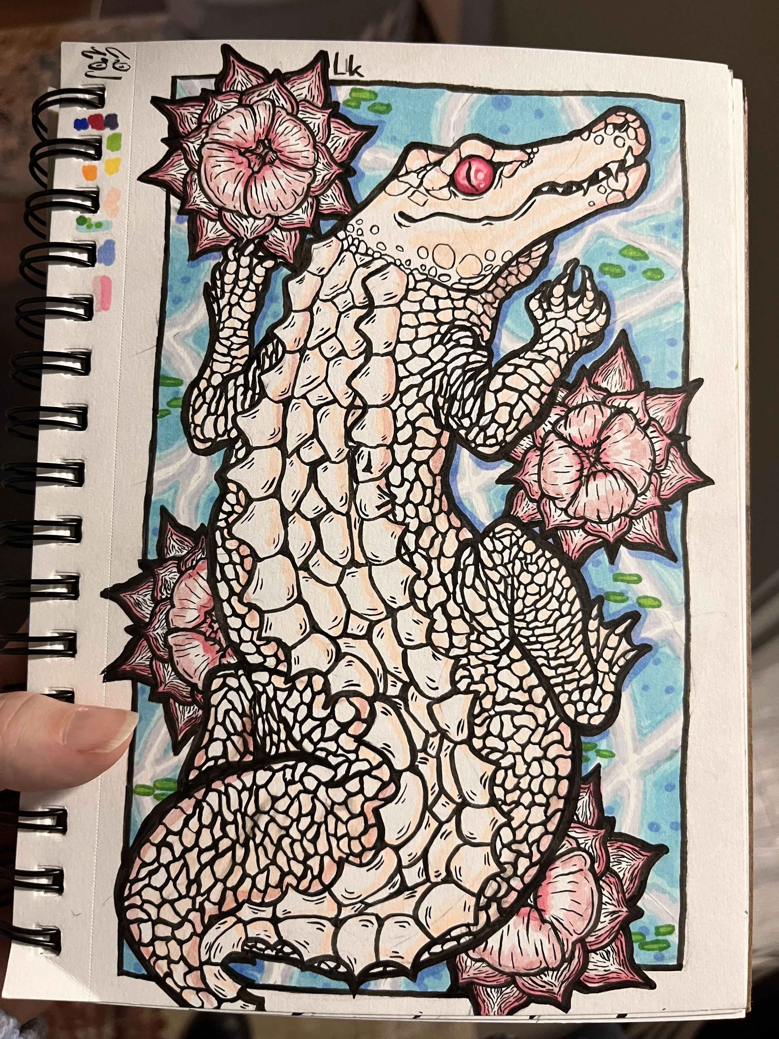 Colorful illustration of a stylized albino alligator surrounded by large pink flowers on a blue and white background.