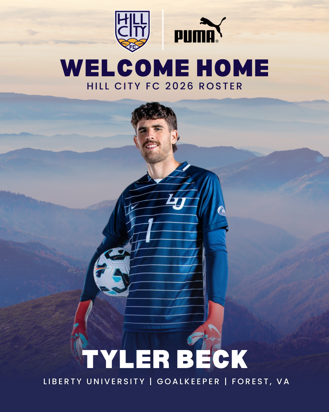 Young man wearing a navy suit and tie, smiling, against a plain white background.