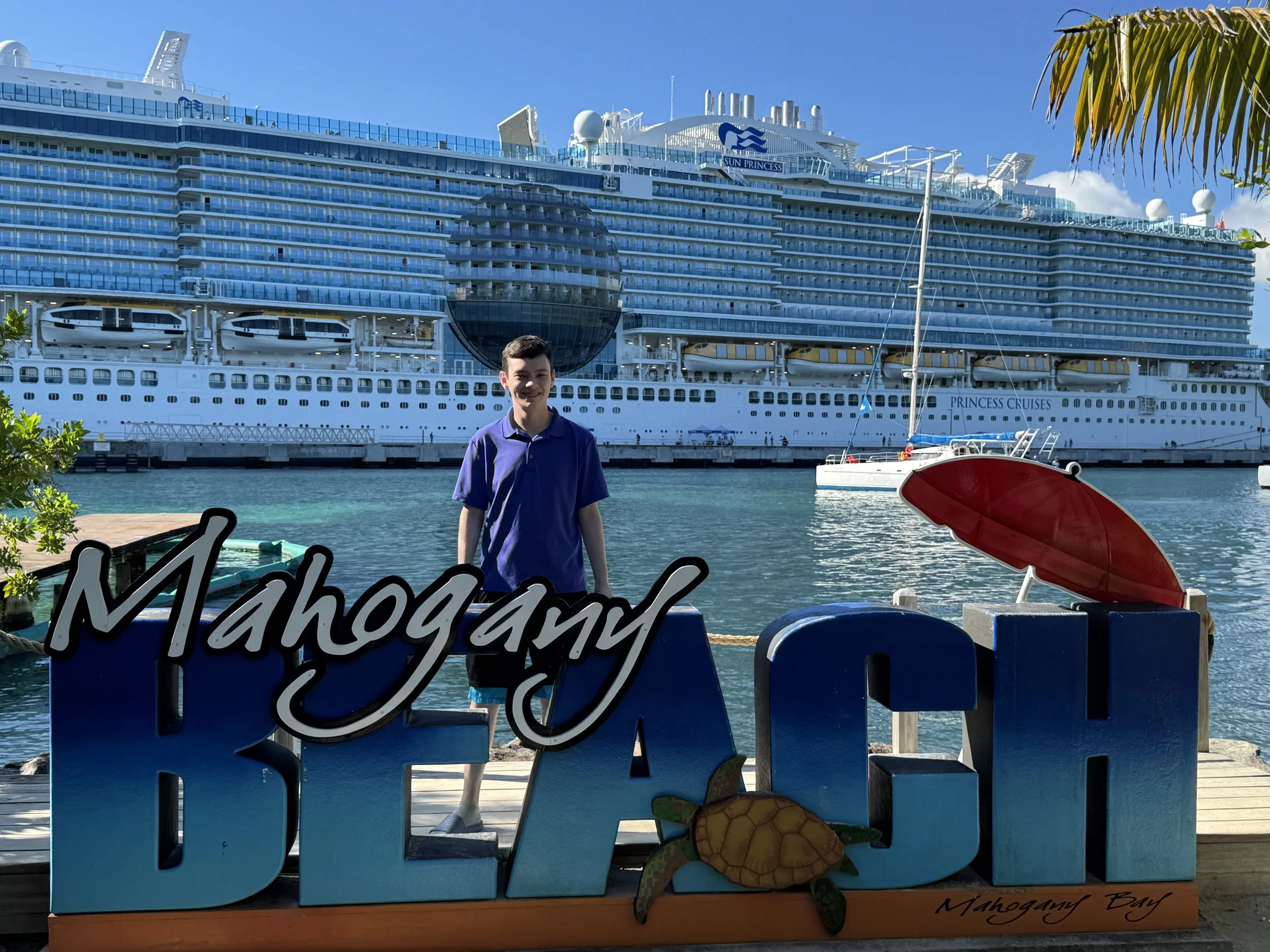 Matthew with Mahogany Bay sign.jpeg