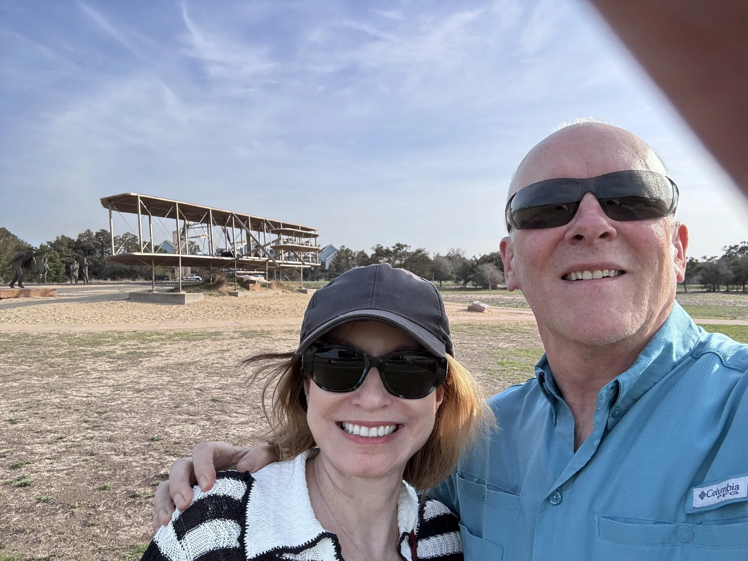 Outside with CD wityh plane in background.jpg