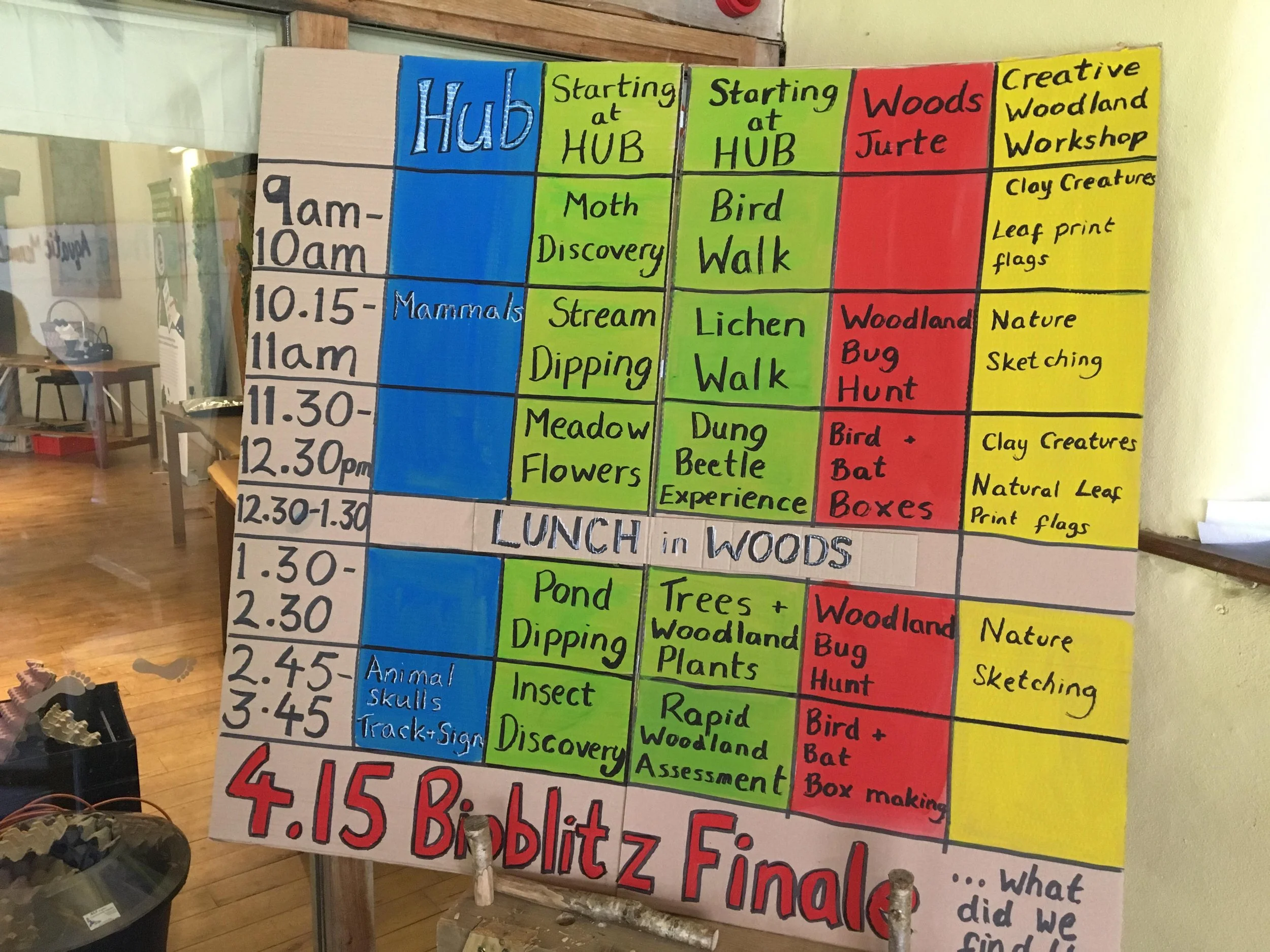 Schedule of activities for children at a woodland workshop, including times and nature exploration themes such as bugs, bird walks, clay creatures, and leaf printing, with sections for different sessions and a lunch break.