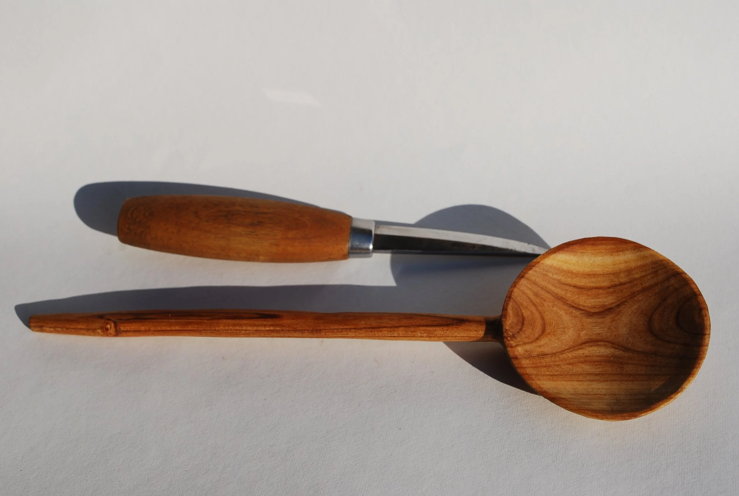 Wooden scoop and wooden spatula on a white background.