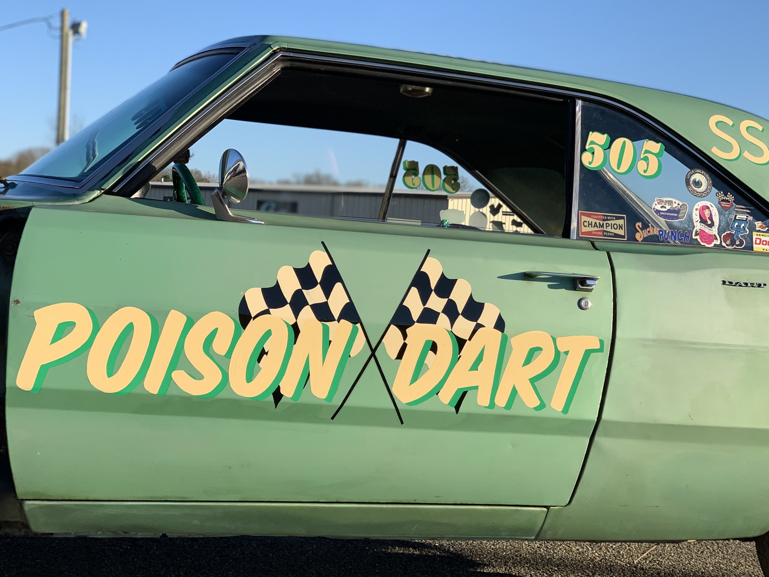Hand lettered "poison dart" with racing flags.