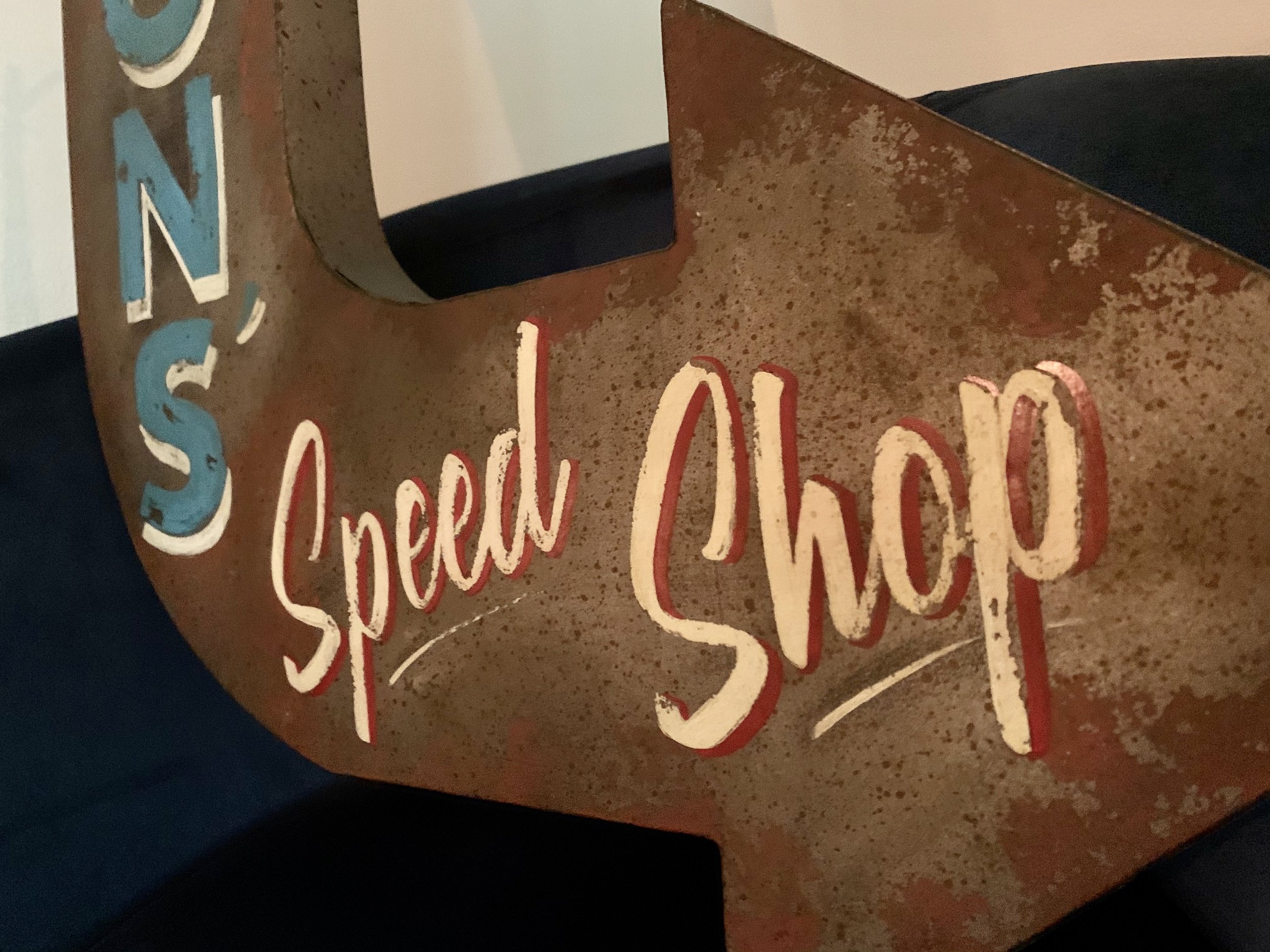 Handpainted and weathered shop sign.