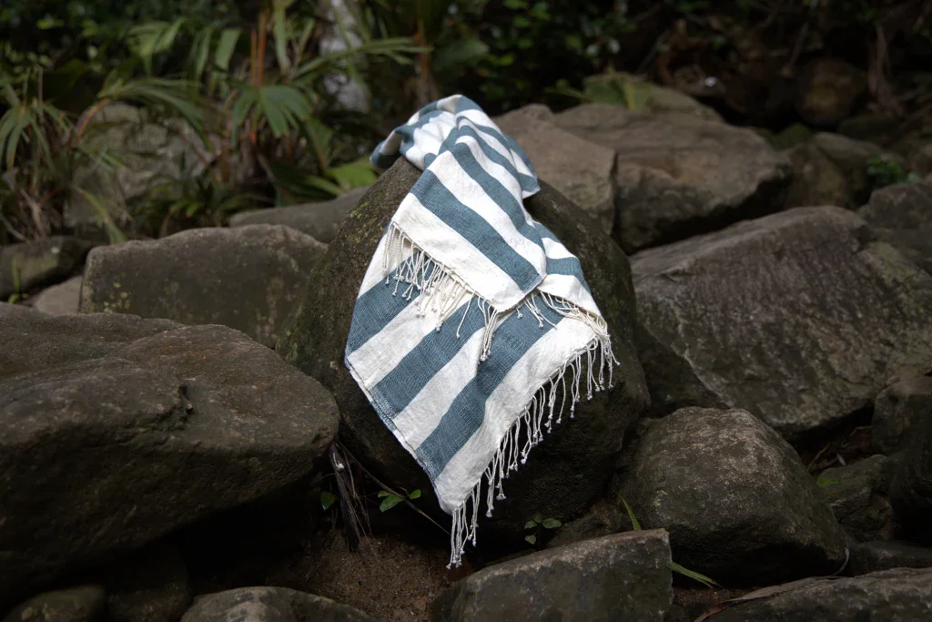 Striped_omo_towel_on_a_rock_with_a_natural_background.webp