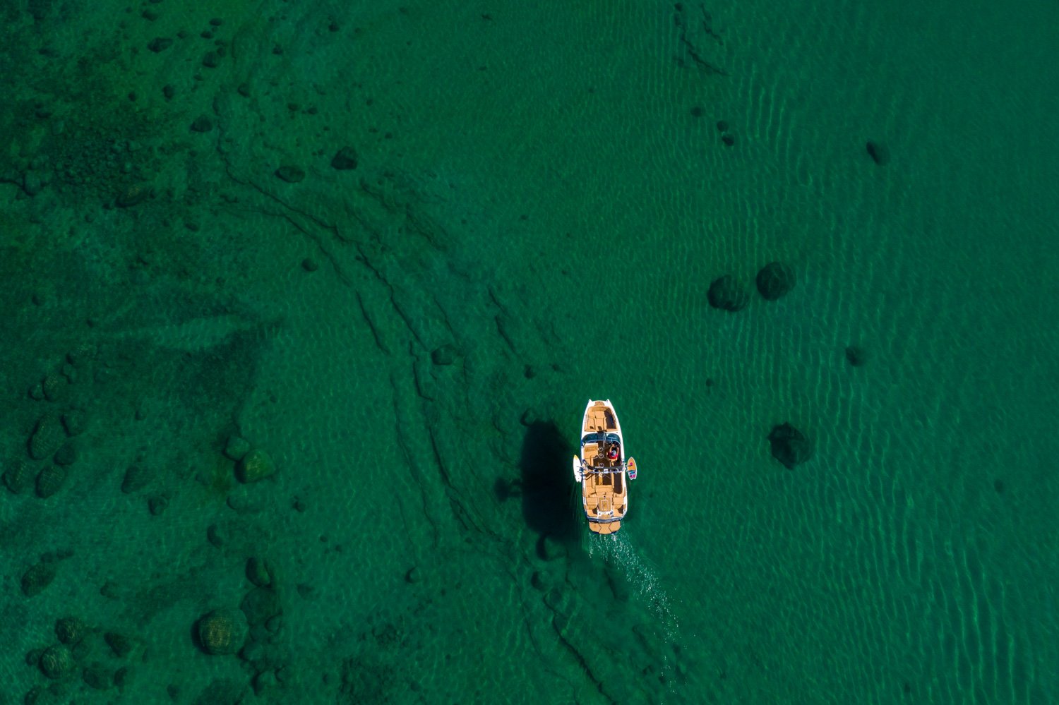 Aerial view of a boat on the East Shore of Lake Tahoe, crystal clear water