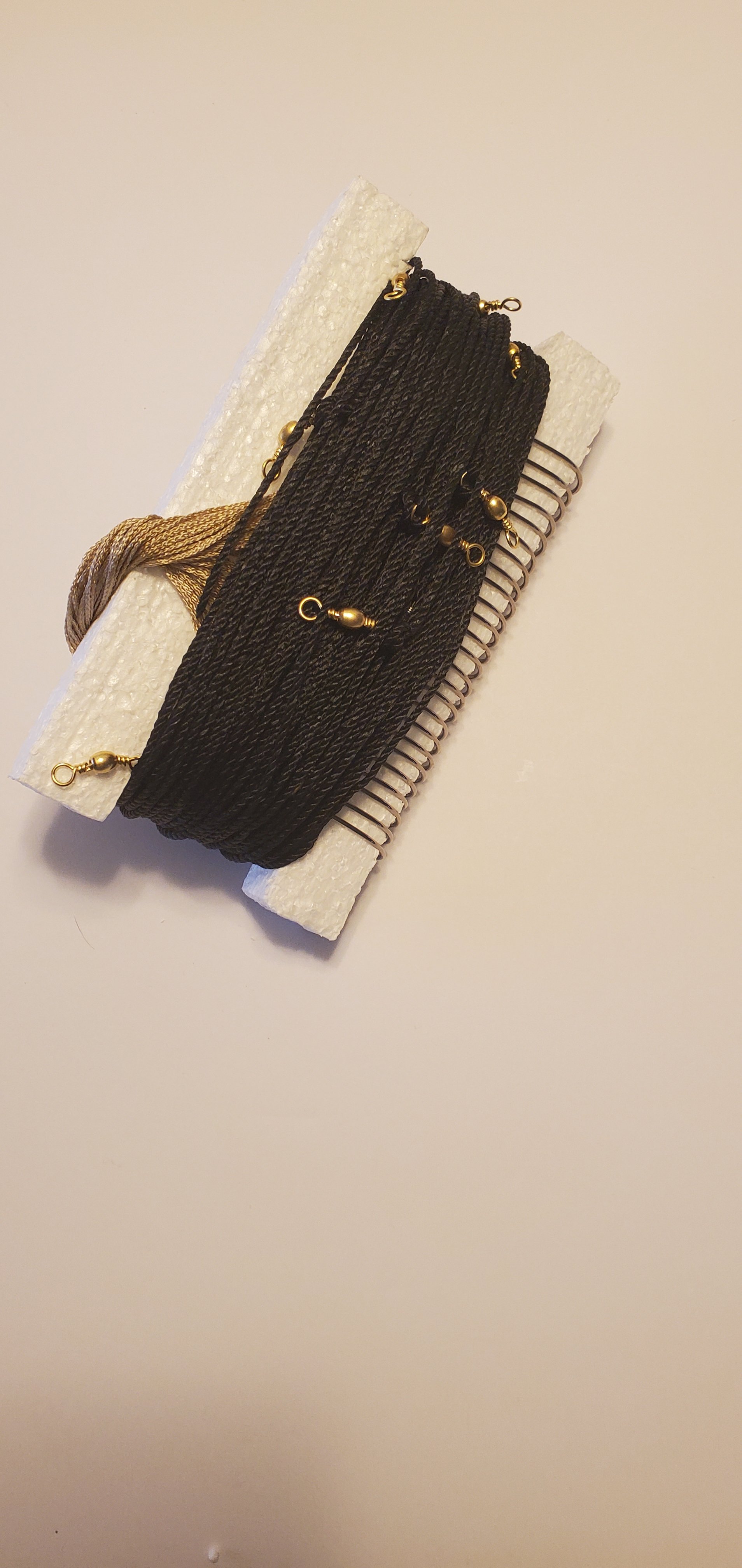 A black tarred trotline on styrofoam