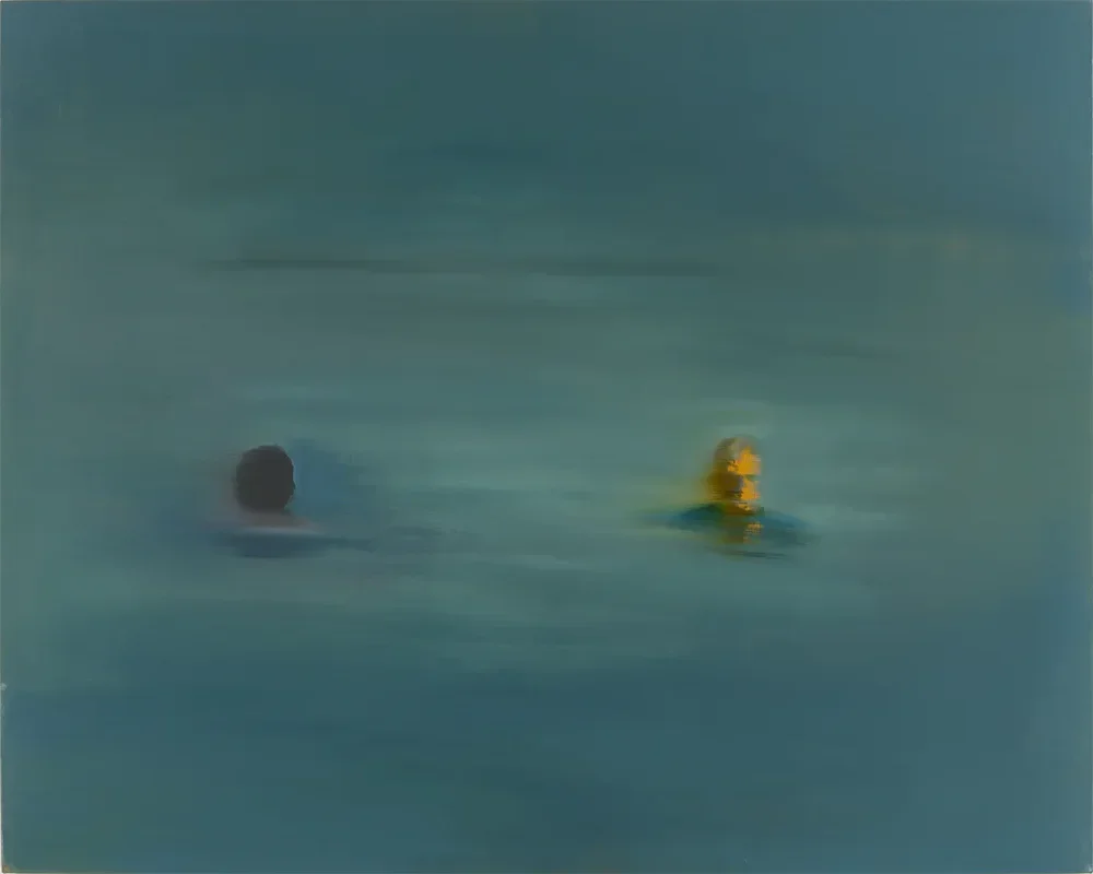 Two people swimming in a body of water, one with dark hair and the other wearing a yellow swimming cap.