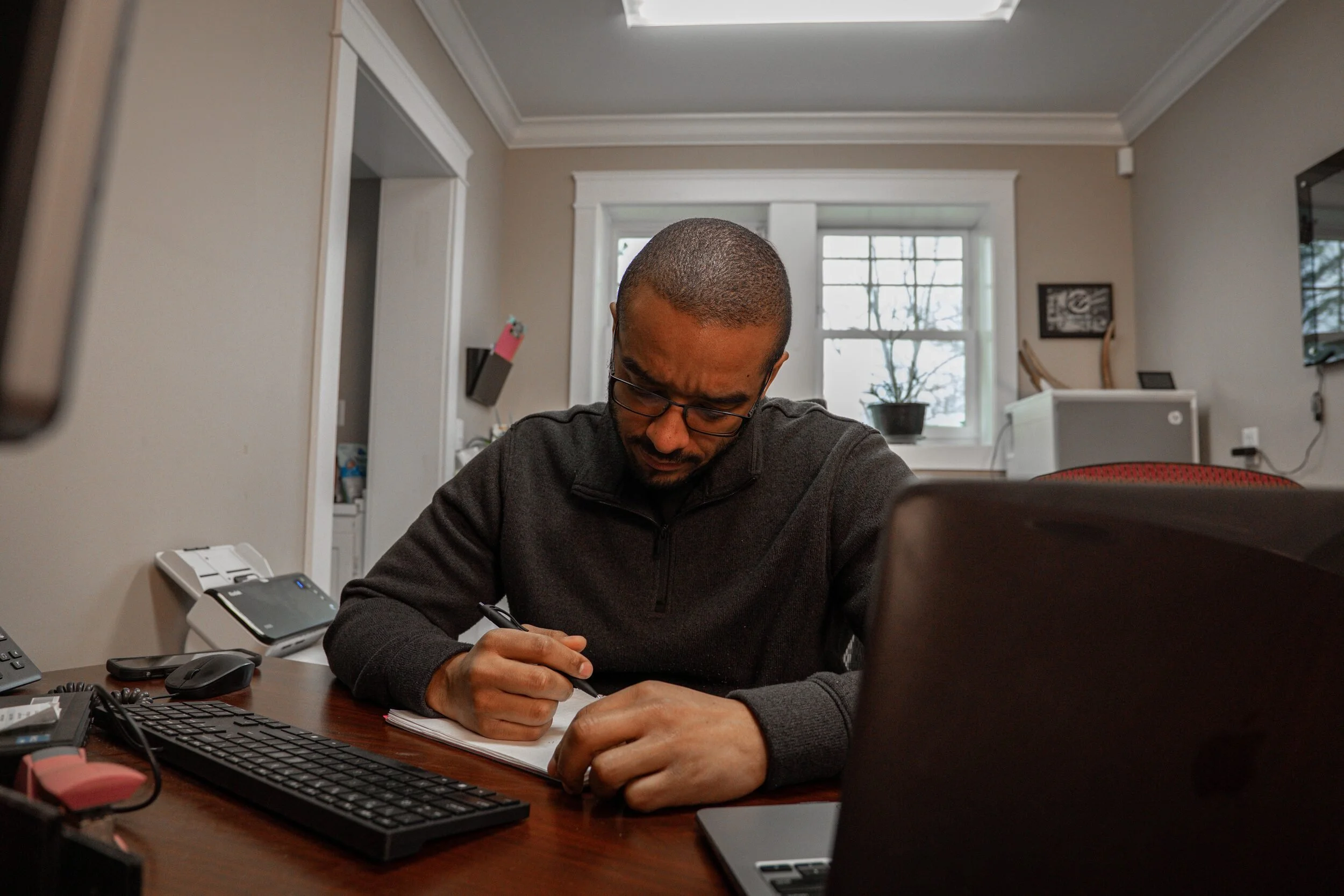 Desmond Haskell planning a custom website project at his desk.