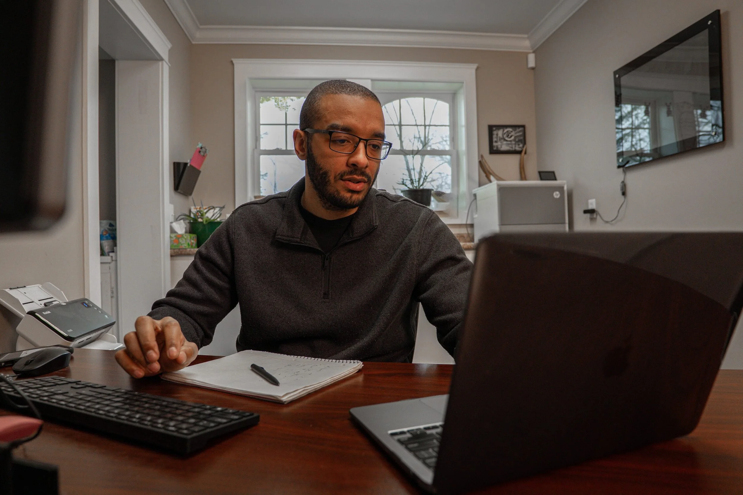 Desmond Haskell working at his desk in the Haskell Digital Services office.