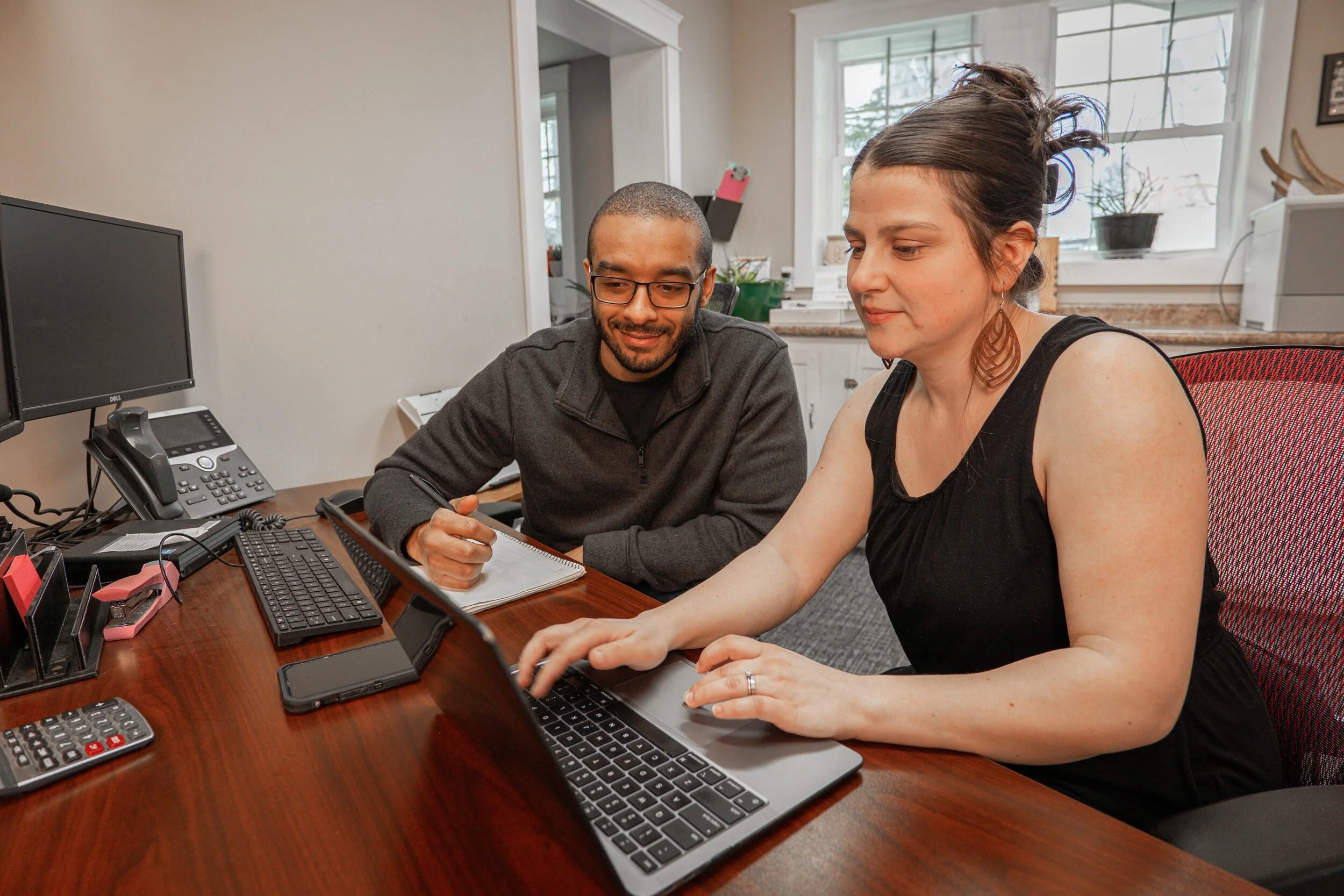 Desmond and Siena Haskell collaborating at their office desks.