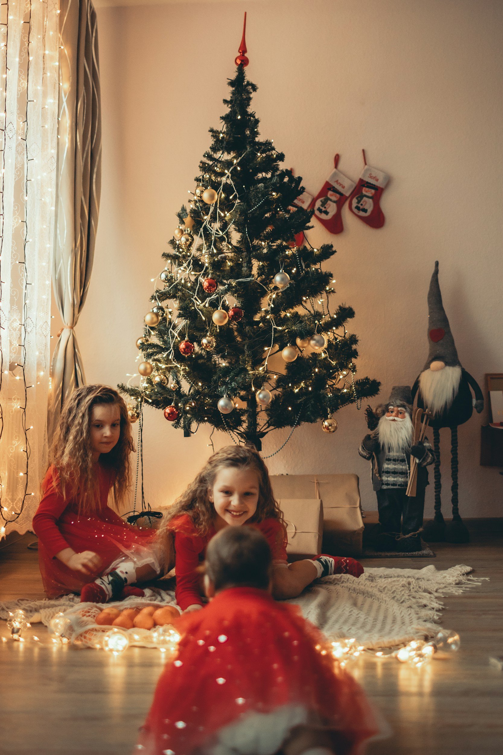 sisters Christmas session in front of tree