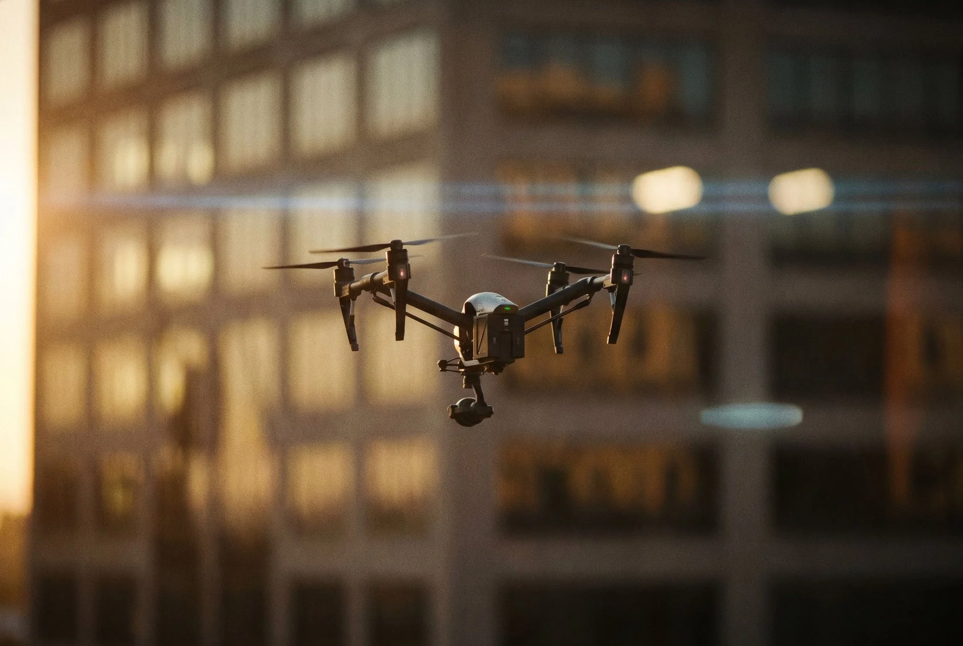Aerial drone hovering at eye level in front of a blurred office building