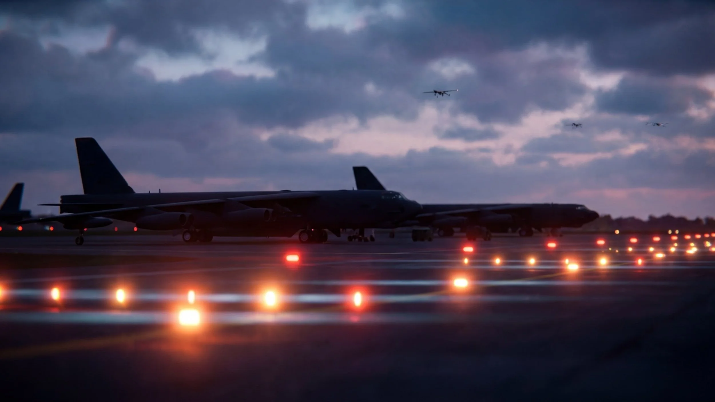 Military aircraft on a runway at dusk with drones approaching overhead, depicting a drone swarm incursion at a secure airbase
