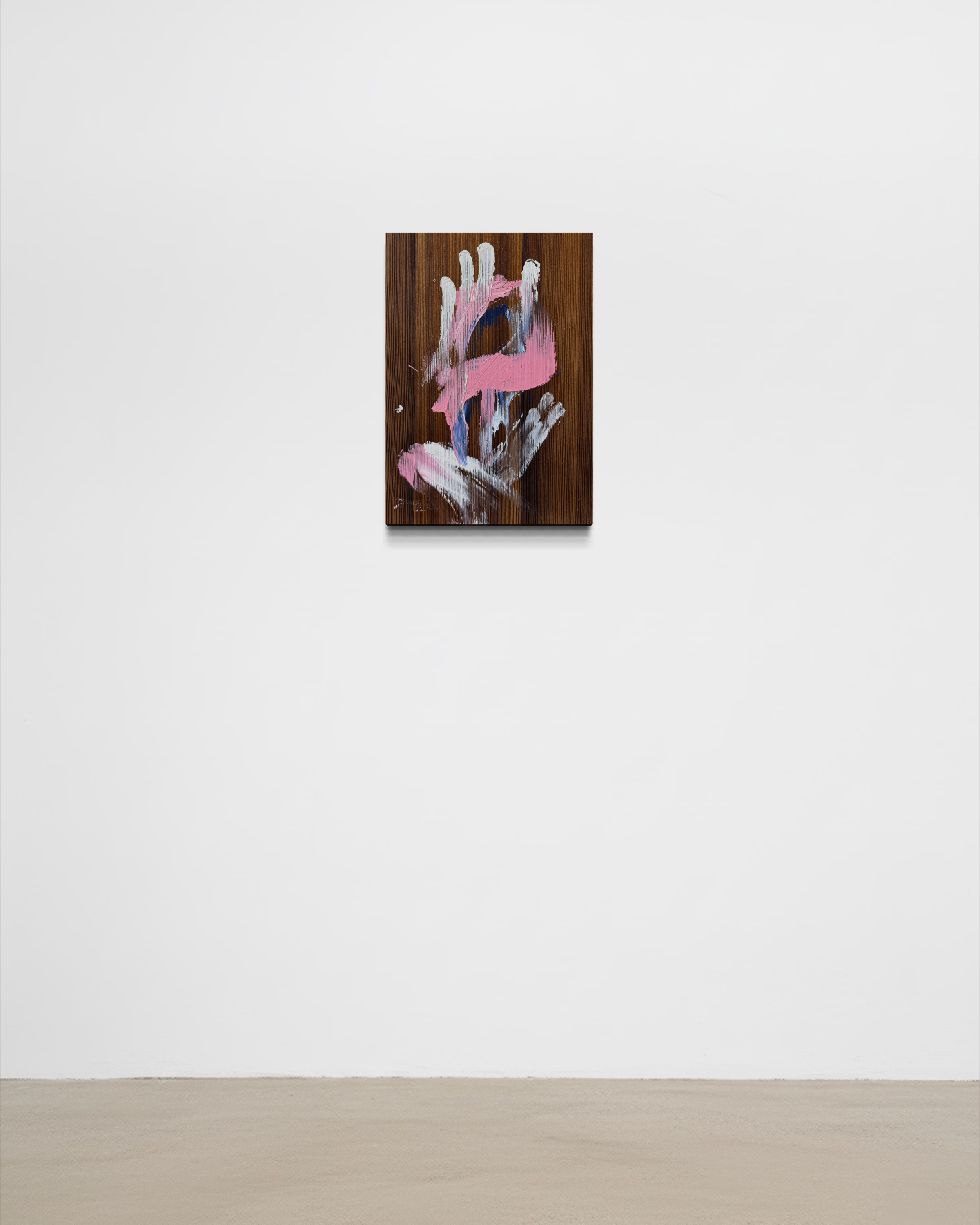 Minimalist art gallery with a painting of abstract hand gestures in pink, white, and blue on a dark wooden background.