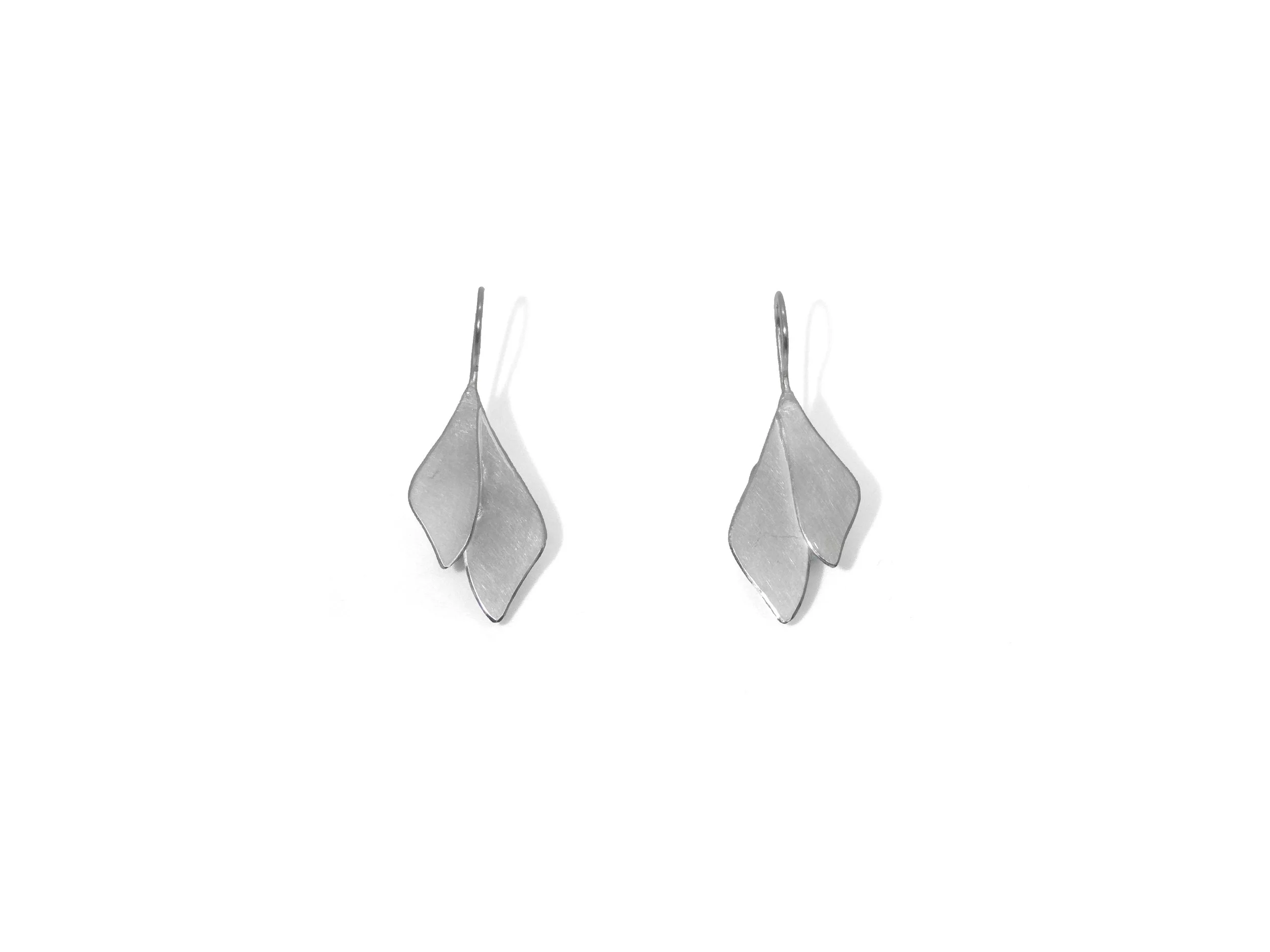 Leaf-shaped metal earrings with matte finish and polished edge