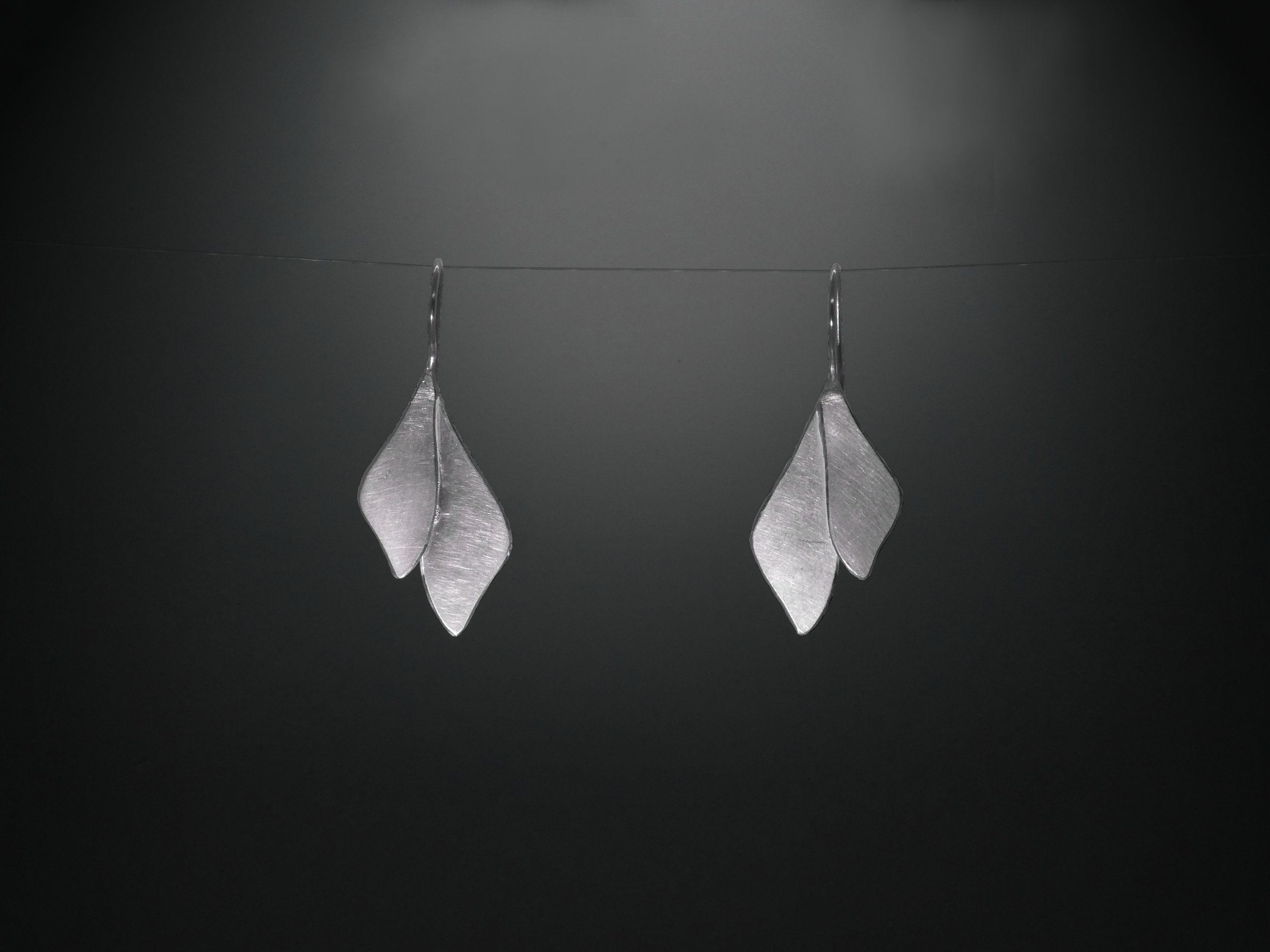 Leaf-shaped matte metal earrings by Julie Usel