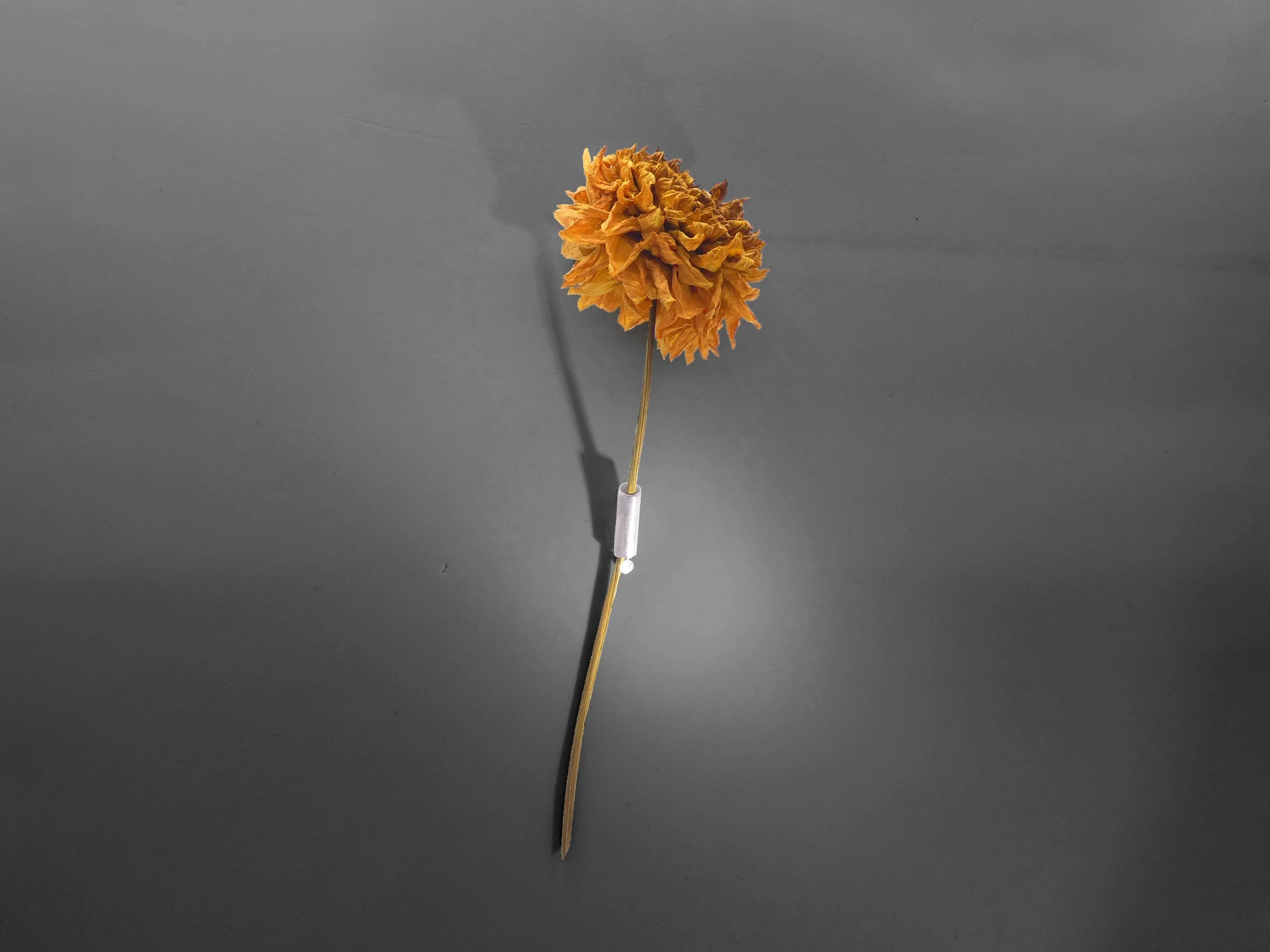 Minimalist silver brooch handmade in Switzerland, contemporary jewelry designed to hold a flower or leaf for a natural, seasonal look