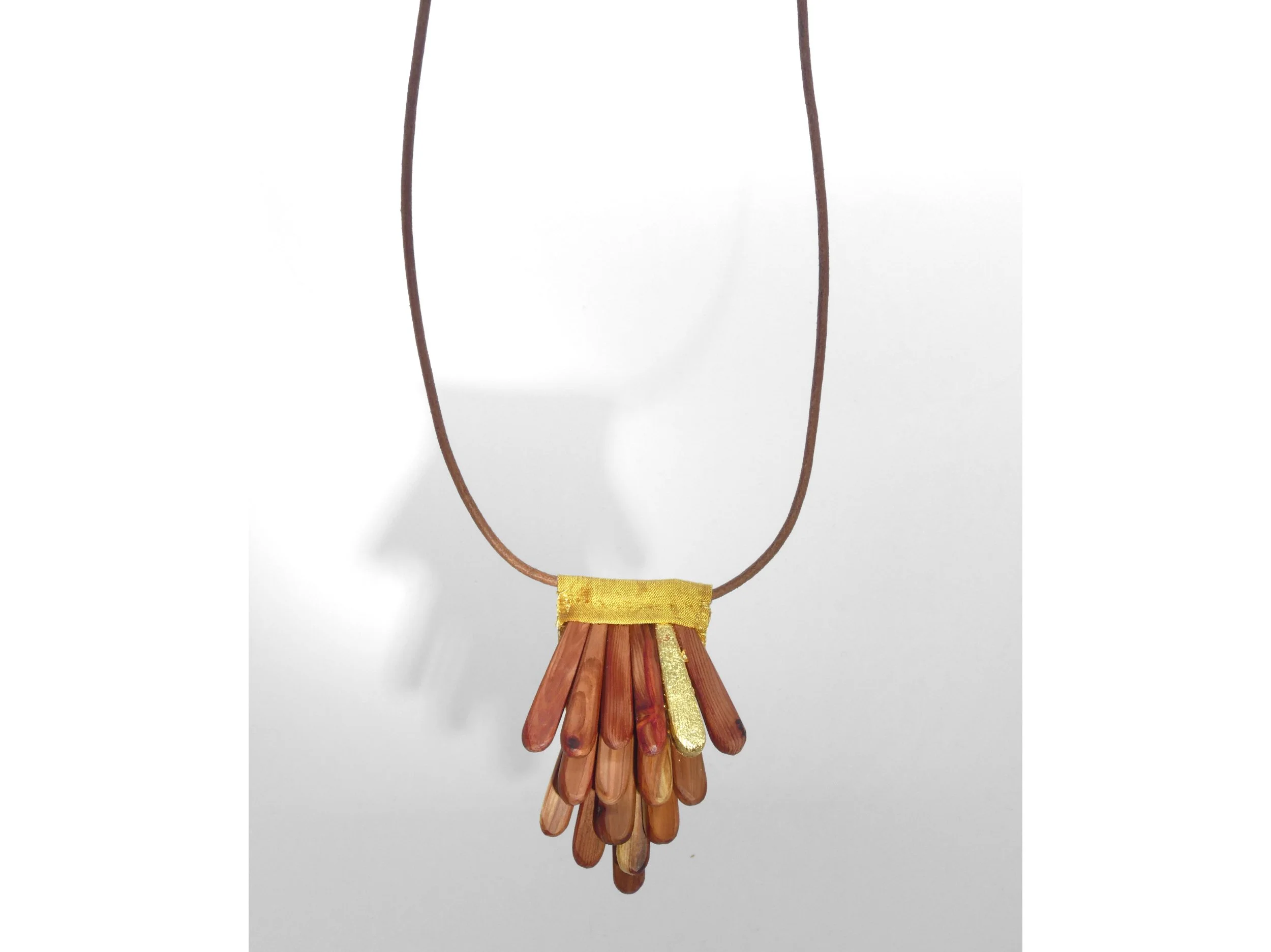 Pomme de pin: hand carved sequoia wood, gold leaf, silk and leather