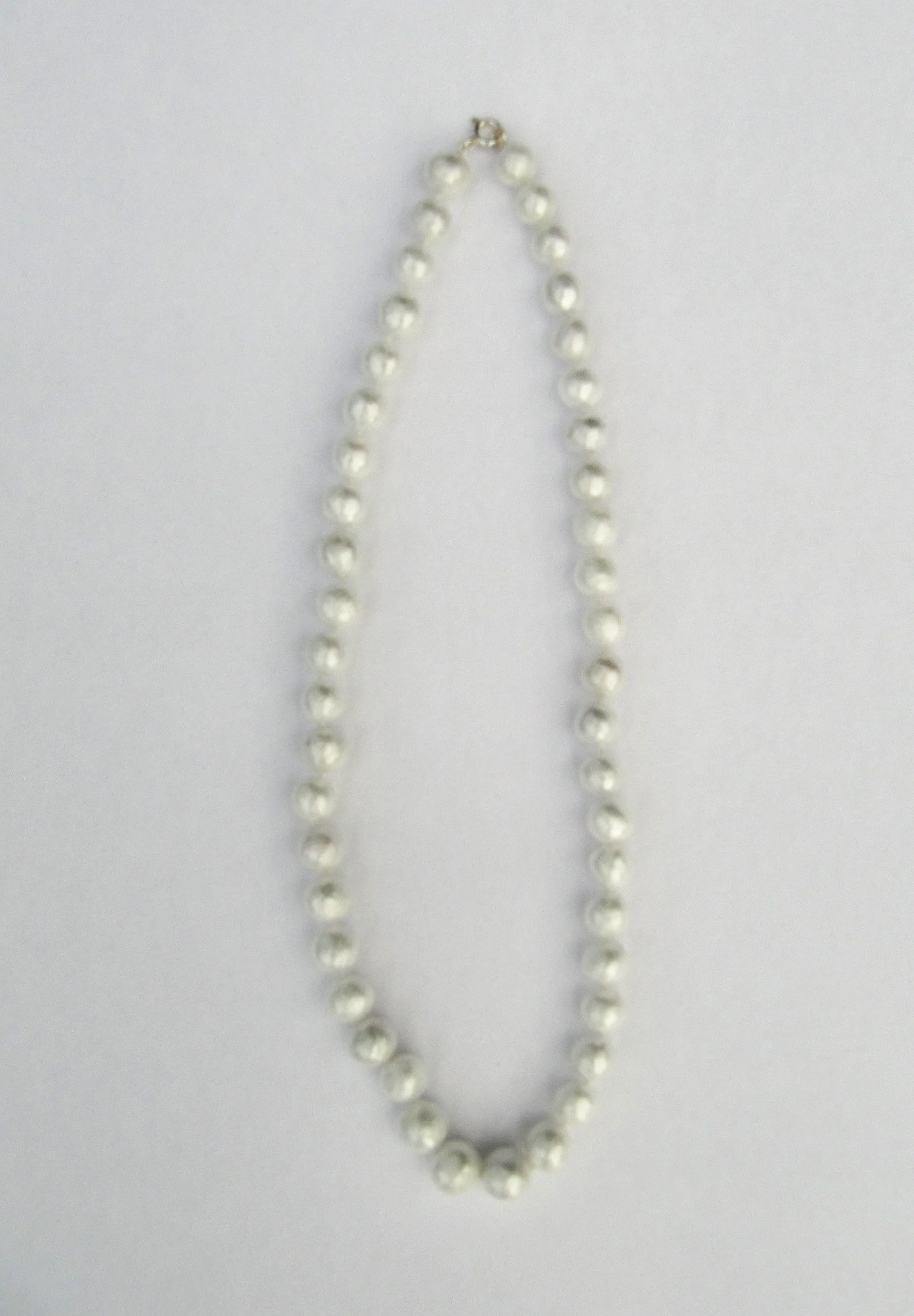 Cling film, many layers of cellophane, silk thread and silver clasp