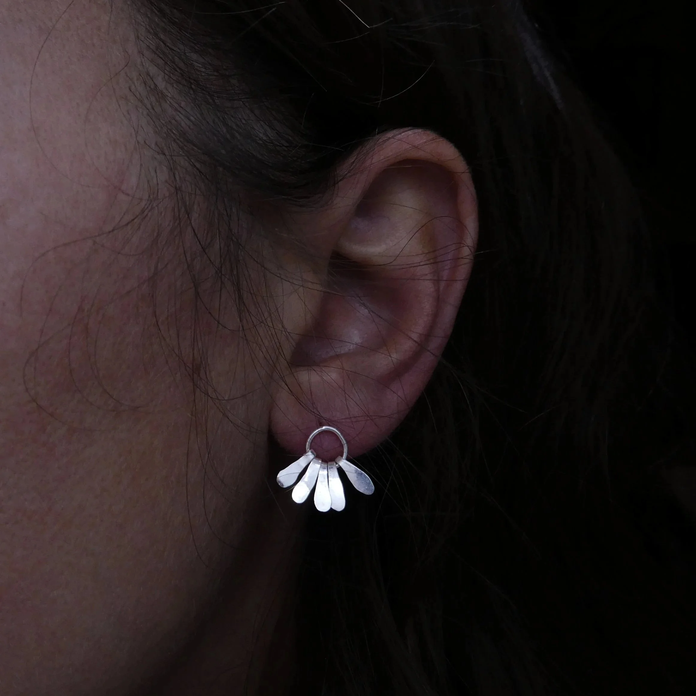 UN PEU: Minimalist silver earrings with delicate hanging petals, handmade in Geneva, Switzerland contemporary jewelry