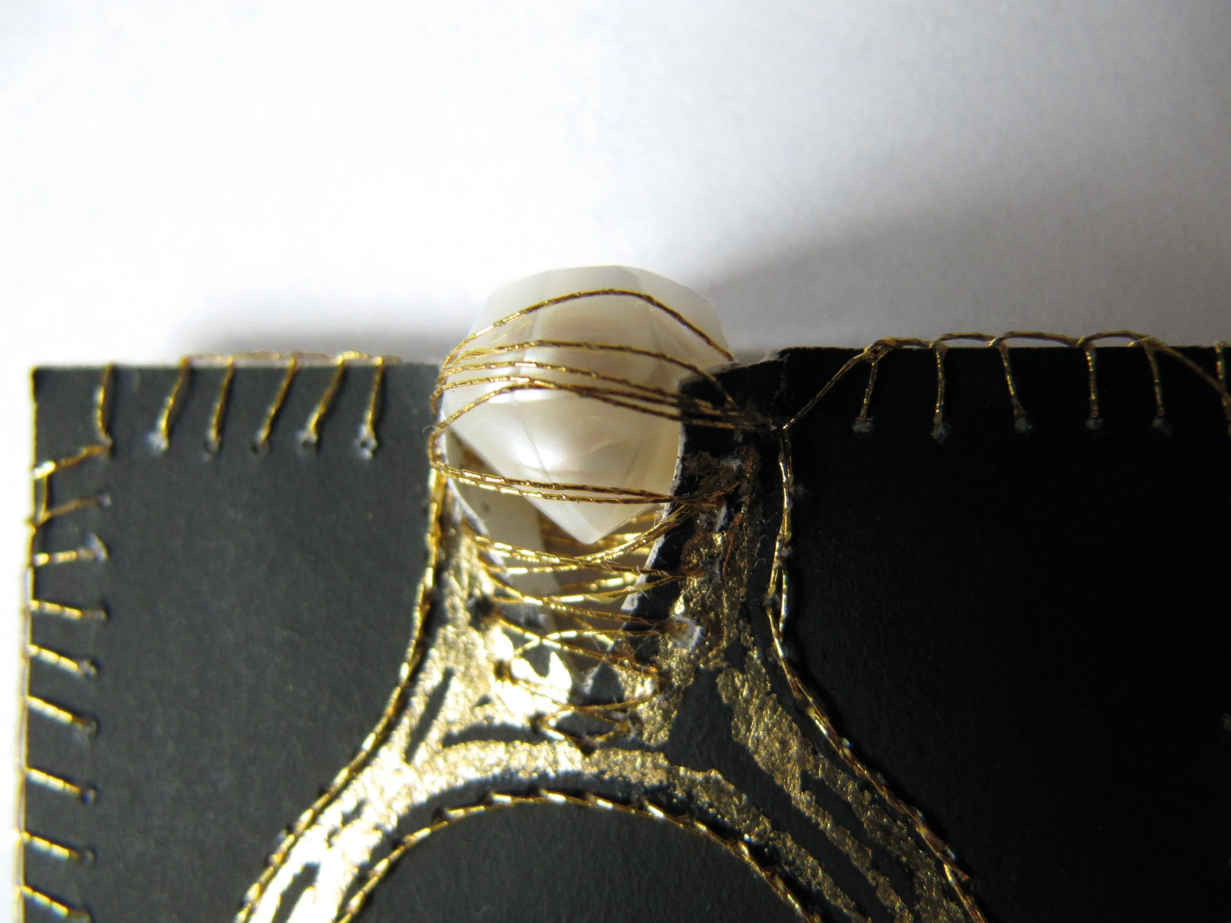 paper ring-object in gold leaf