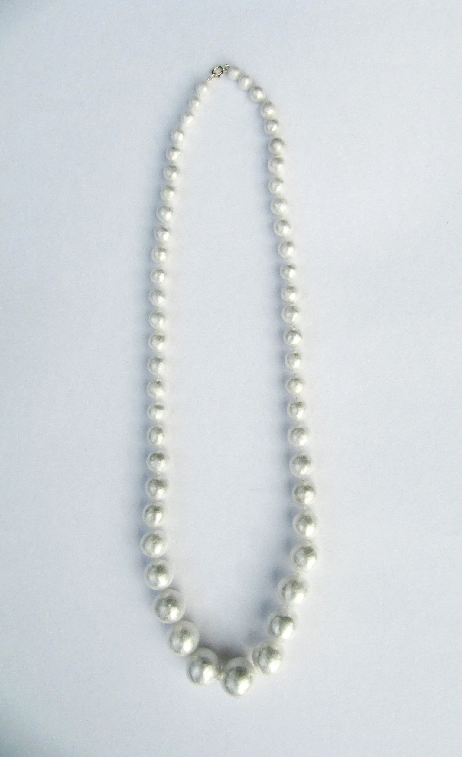 Cling film, many layers of cellophane, silk thread and silver clasp