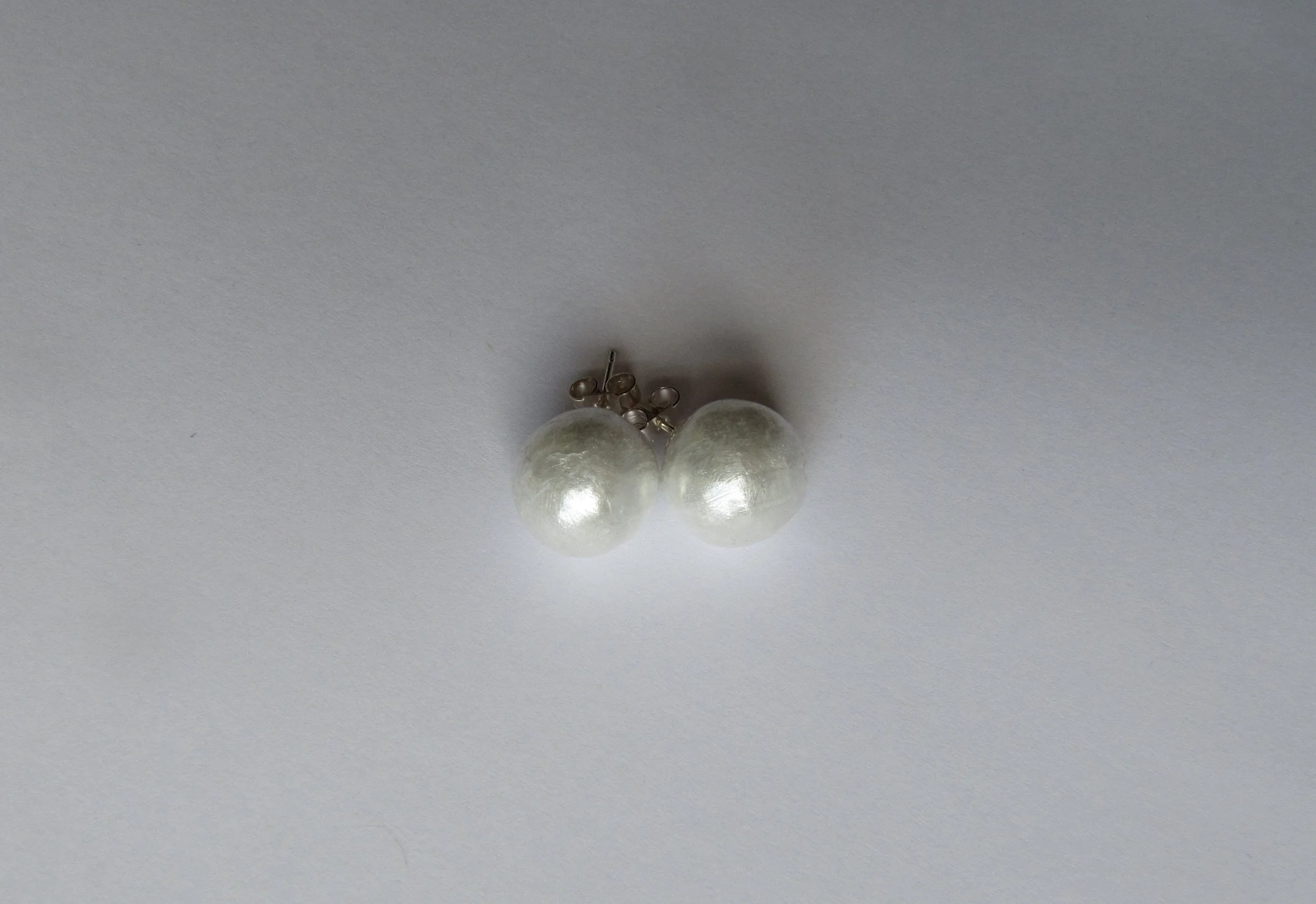 Cling film, many layers of cellophane and silver ear stud