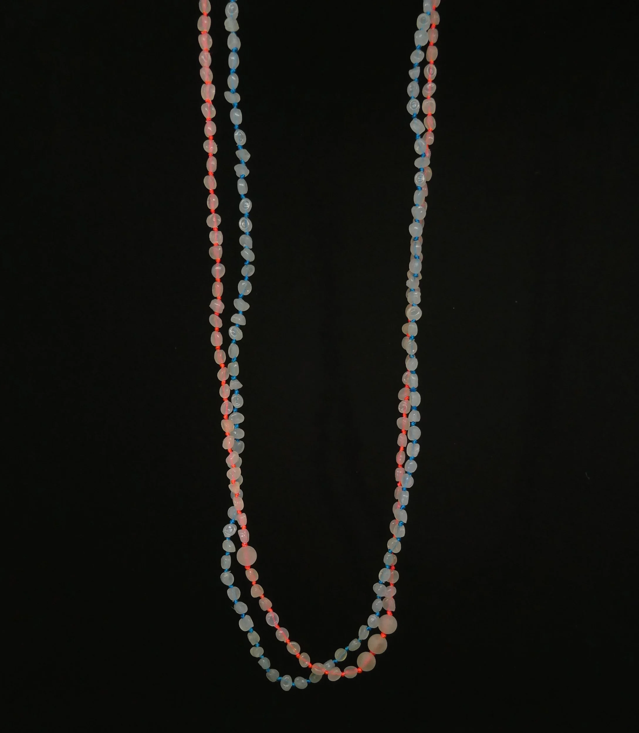 Beach beads, mini plastic pellets found on beaches and pierced, then knotted like precious pearls of coloured thread