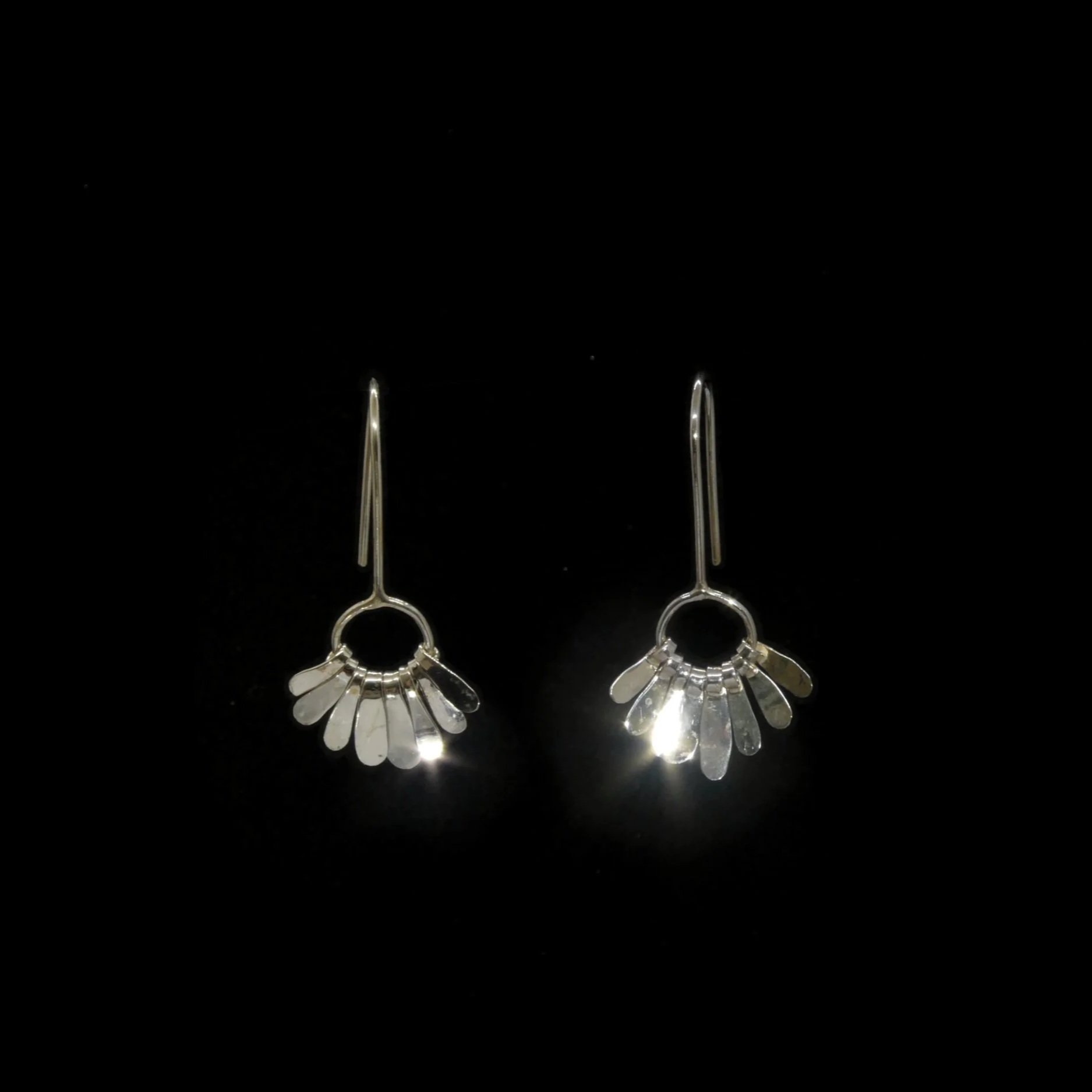 Paquerette: Silver daisy-inspired earrings with dangling petals, handmade in Switzerland contemporary jewelry