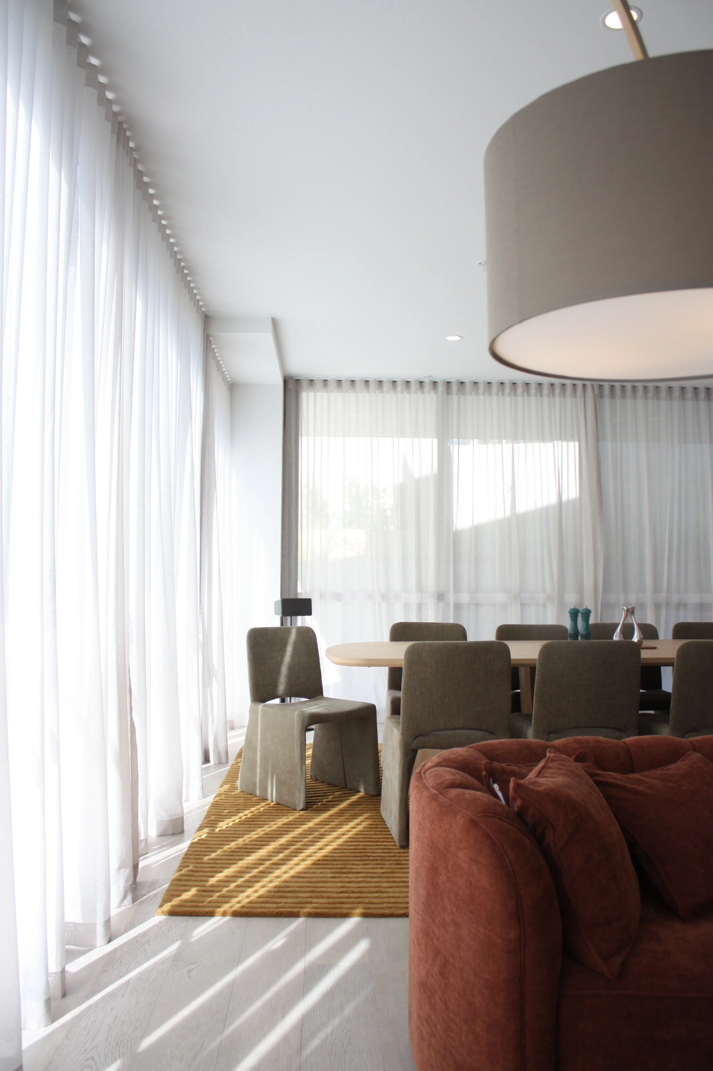 Serpells Place Apartment in Templestowe open plan living and dining room decorated and styled in an MCM fashion with a large dining table and dining chairs from Globewest and a Living By Design couch