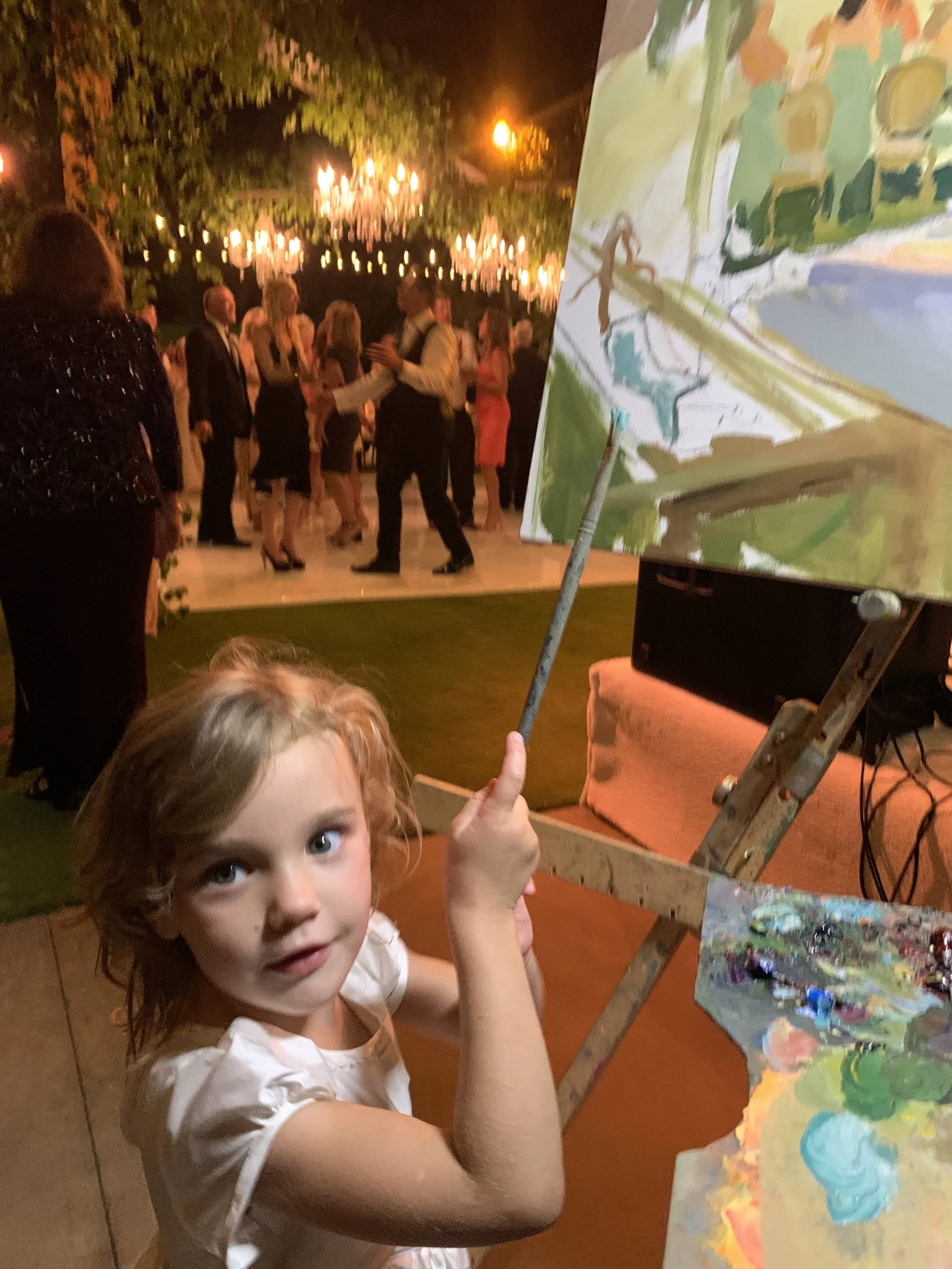 little girl painting a mermaid onto a live wedding painting by Laura Jane Fine Art