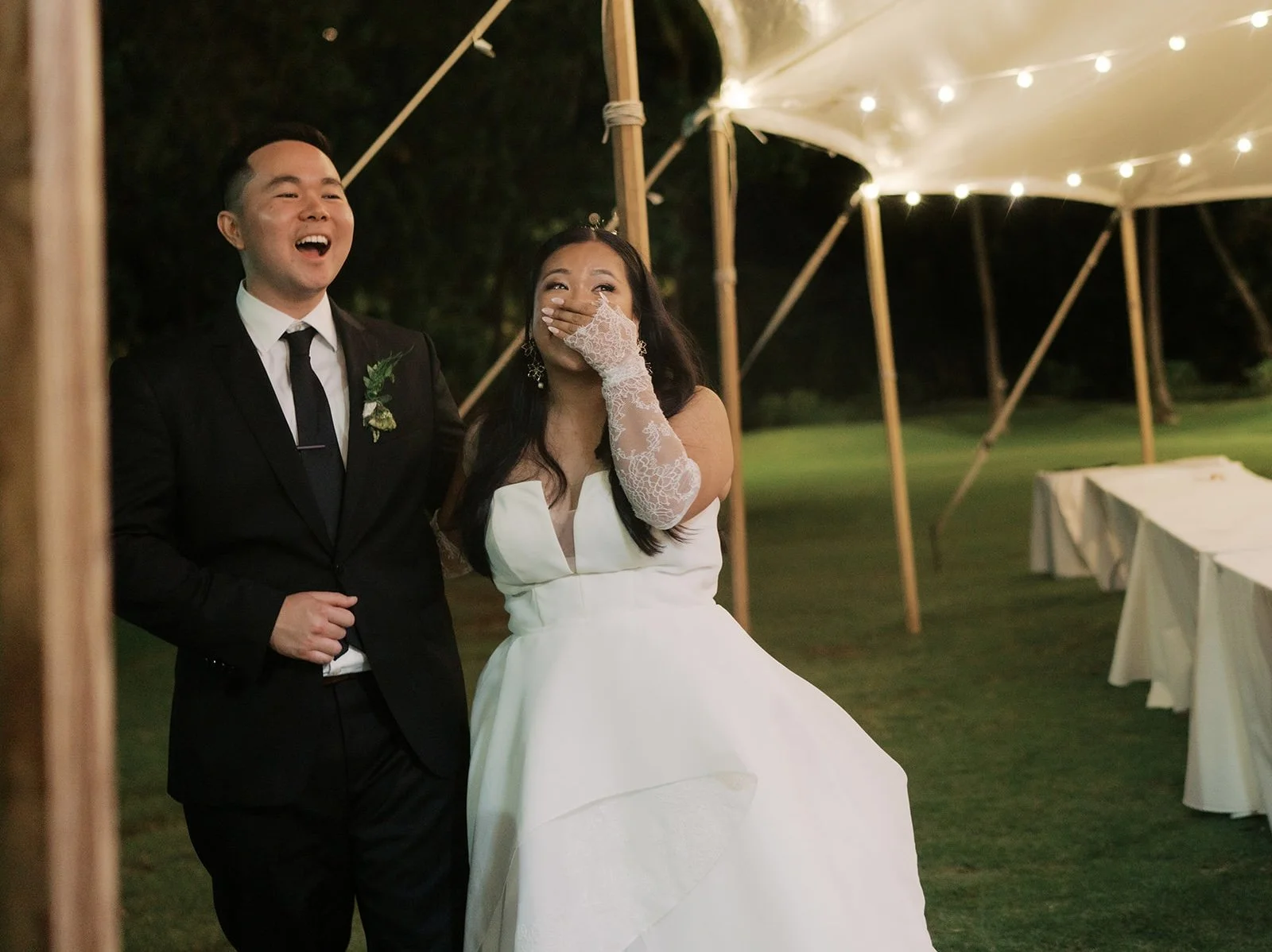 Couple's reaction to their live wedding painting on the lawn at night at Lanikuhonua.