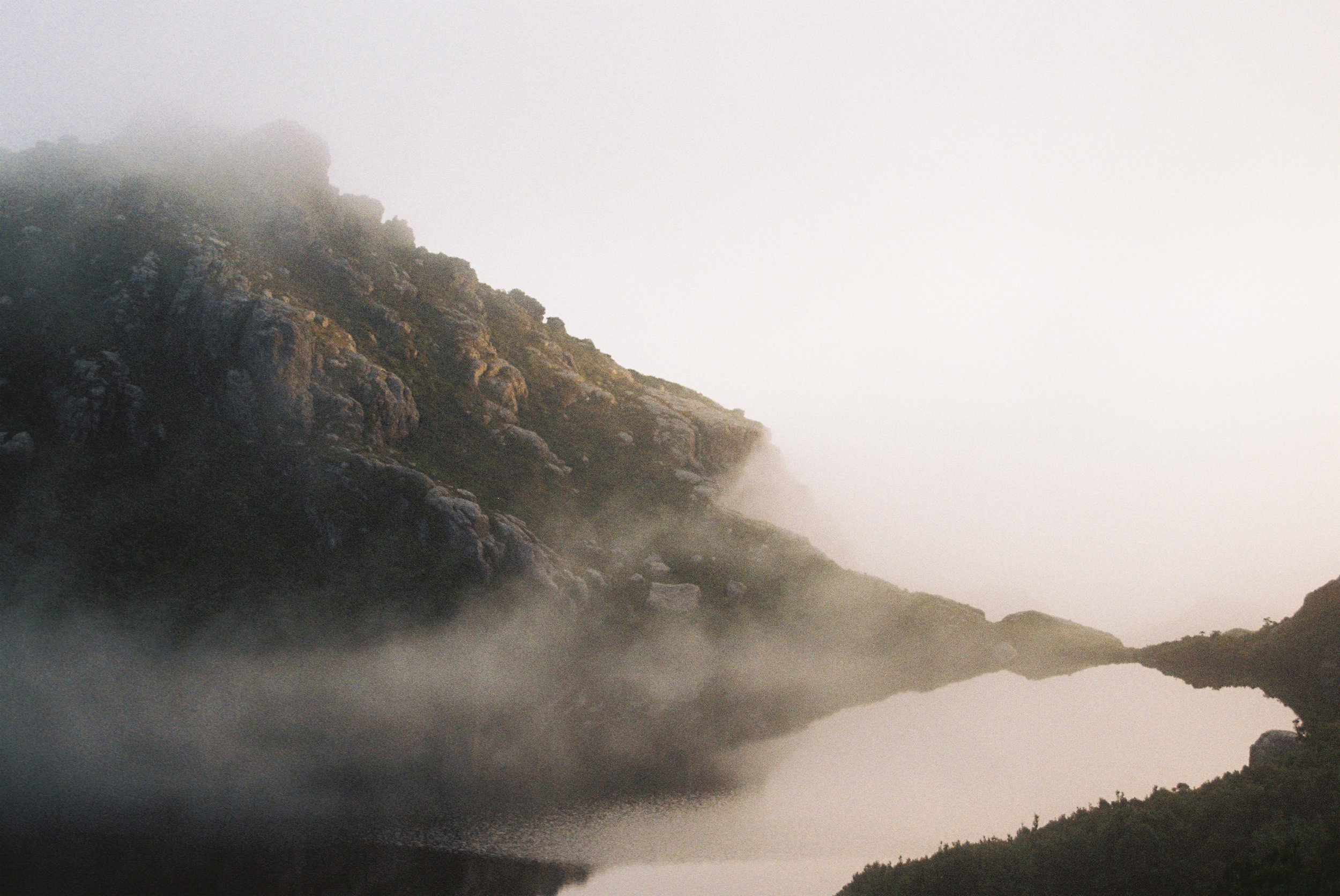 Low cloud covering an alpine lake in the Western Arthurs, Tasmania, showing reduced visibility during unstable trough weather.