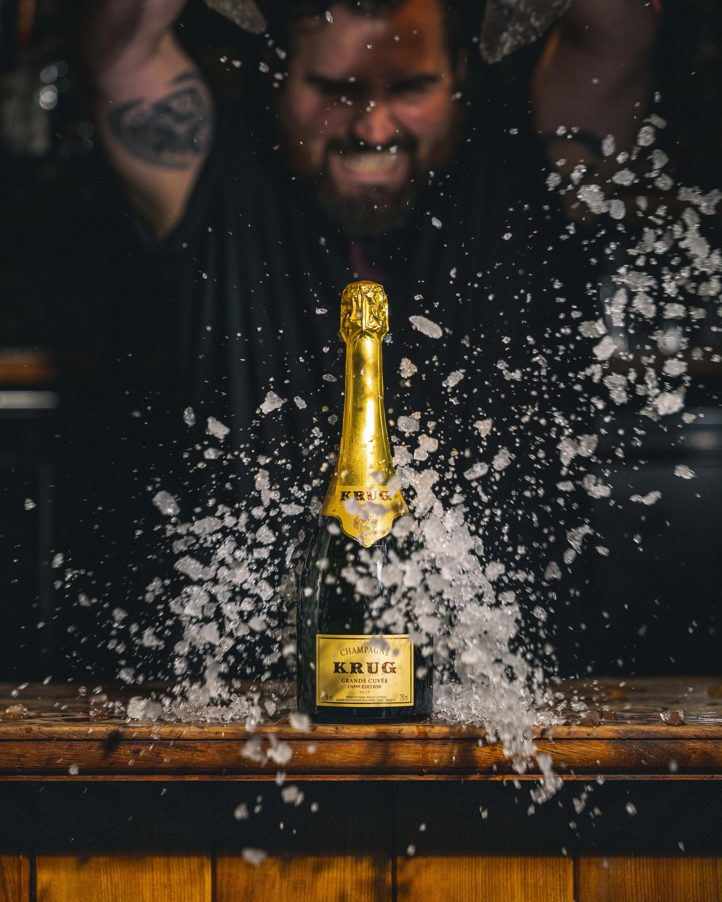 Champagne bottle bursting open at a celebratory event.