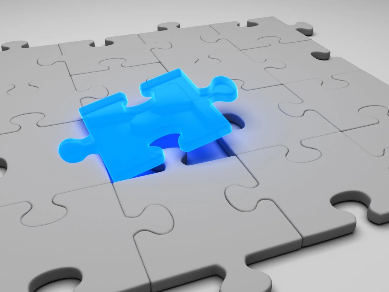 Single blue puzzle piece fitting into a white puzzle.