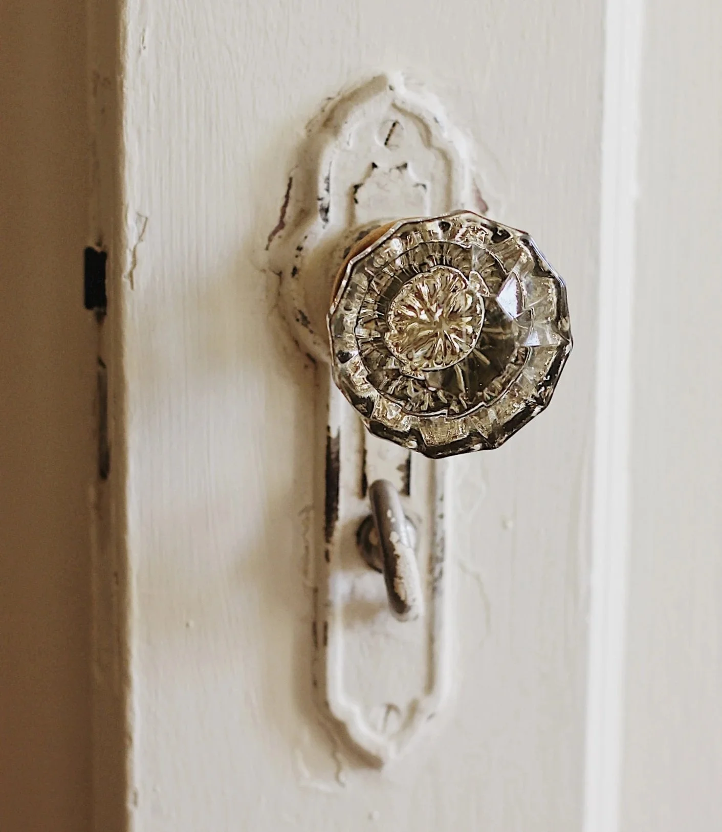 Close-up of a door handle and lock on a white interior door.
