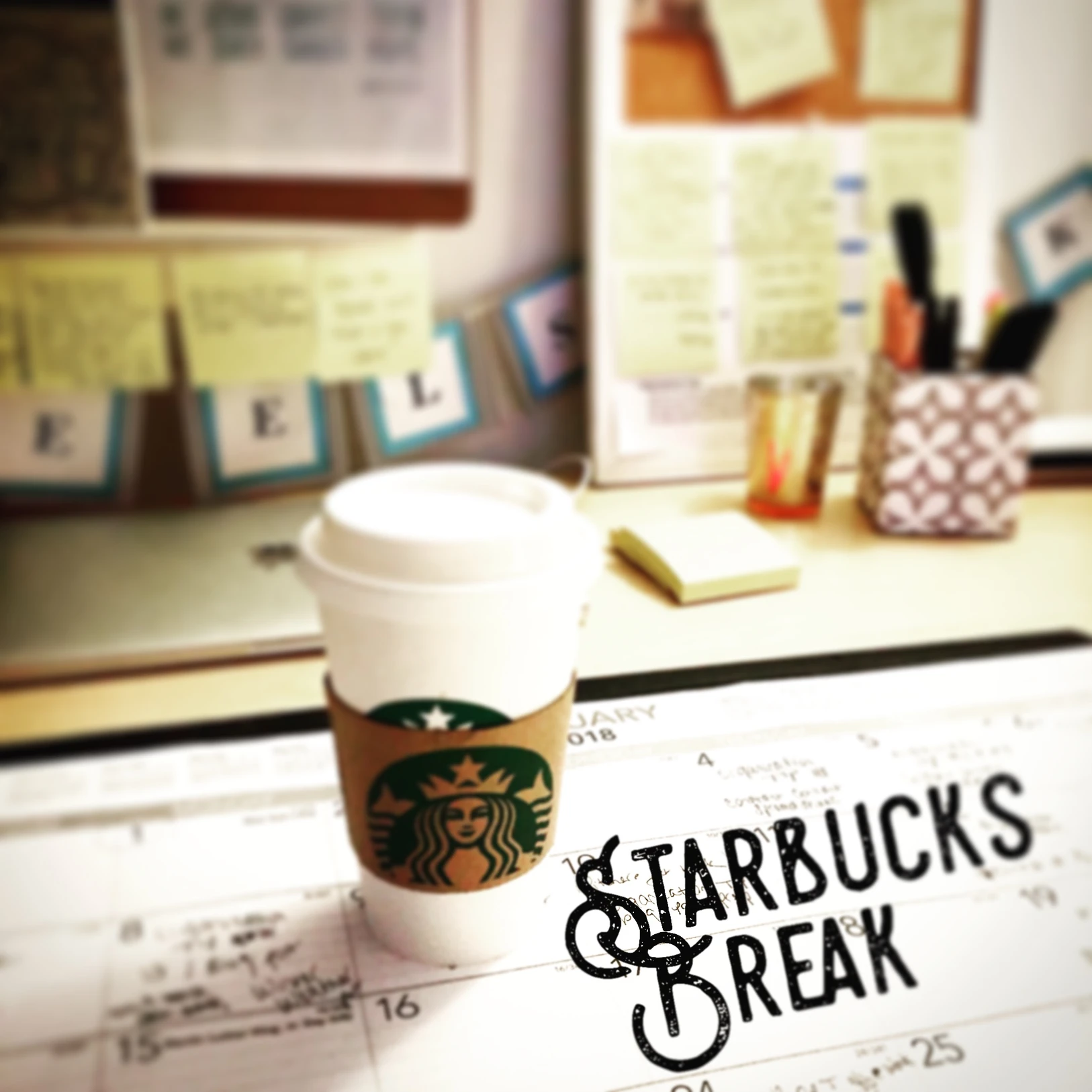 Coffee cup on desk with calendar and notes, representing taking a break during organizing.